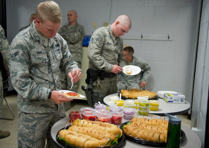 Members of the 49th Security Forces Squadron enjoy food supplied by Holloman’s Middle 2 as a part of the random acts of kindness program June 24, 2015 at Holloman Air Force Base , N.M. With the 49th SFS being the focus the Middle 2 decided they would supply the defenders, who are often stuck at the gate or in the office, without quality food and drink to ease the burden of not being able to depart from their post during shift. (Photo by U.S. Air Force Staff Sgt. Stacy Moless)