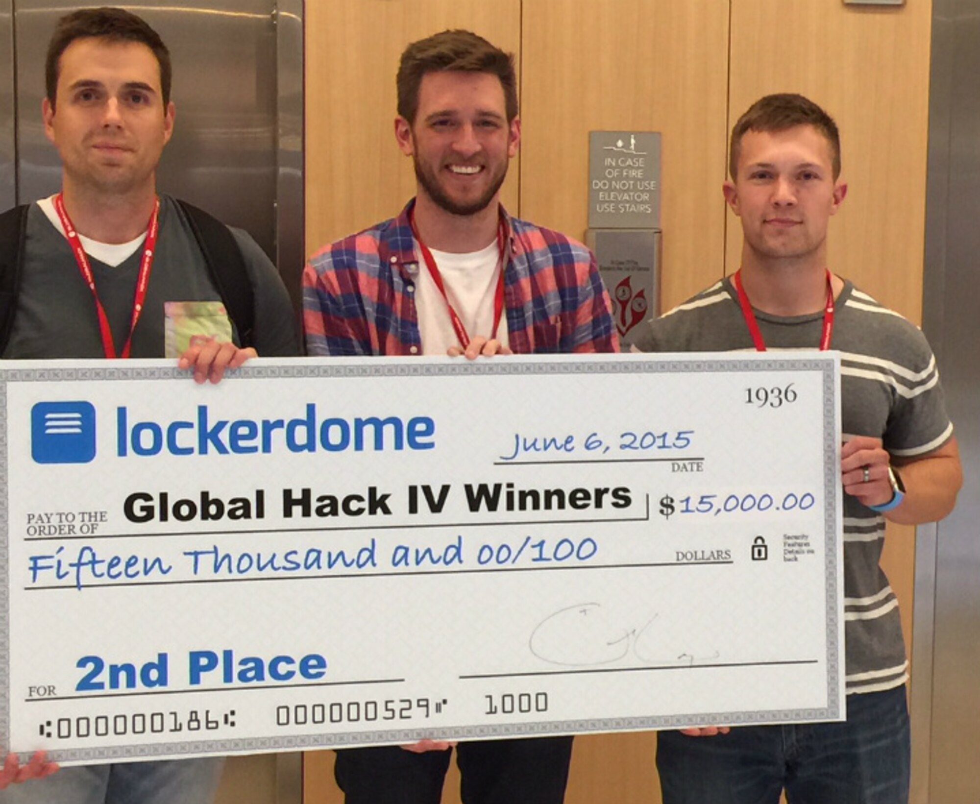 First Lt. Bradford Law, 38th Cyberspace Readiness Squadron, 1st Lt. Paul Jordan, Air Force Space Command, and teammate Chase Clettenberg (center), are awarded second place in GlobalHack IV June 7. Law and Jordan are two cyber Airmen who work to keep their skills sharp by melding their personal and professional interests, like participating in a local "Hack-a-thon" where competitors solved real-world problems by programming software. (Courtesy photo)