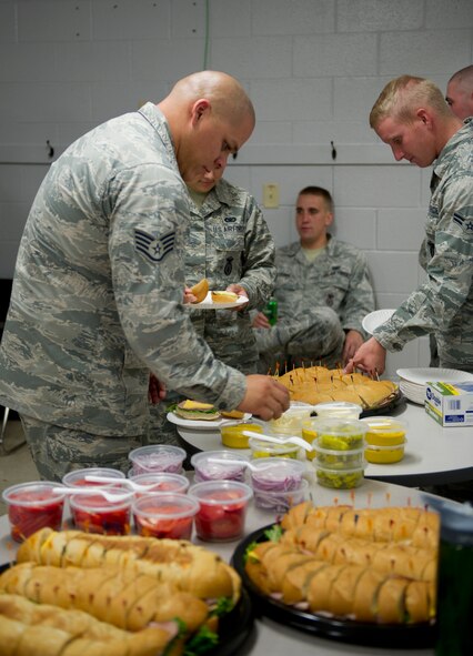 Members of the 49th Security Forces Squadron enjoy food supplied by Holloman’s Middle 2 as a part of the random acts of kindness program June 24, 2015 at Holloman Air Force Base , N.M. With the 49th SFS being the focus the Middle 2 decided they would supply the defenders, who are often stuck at the gate or in the office, without quality food and drink to ease the burden of not being able to depart from their post during shift. (Photo by U.S. Air Force Staff Sgt. Stacy Moless)