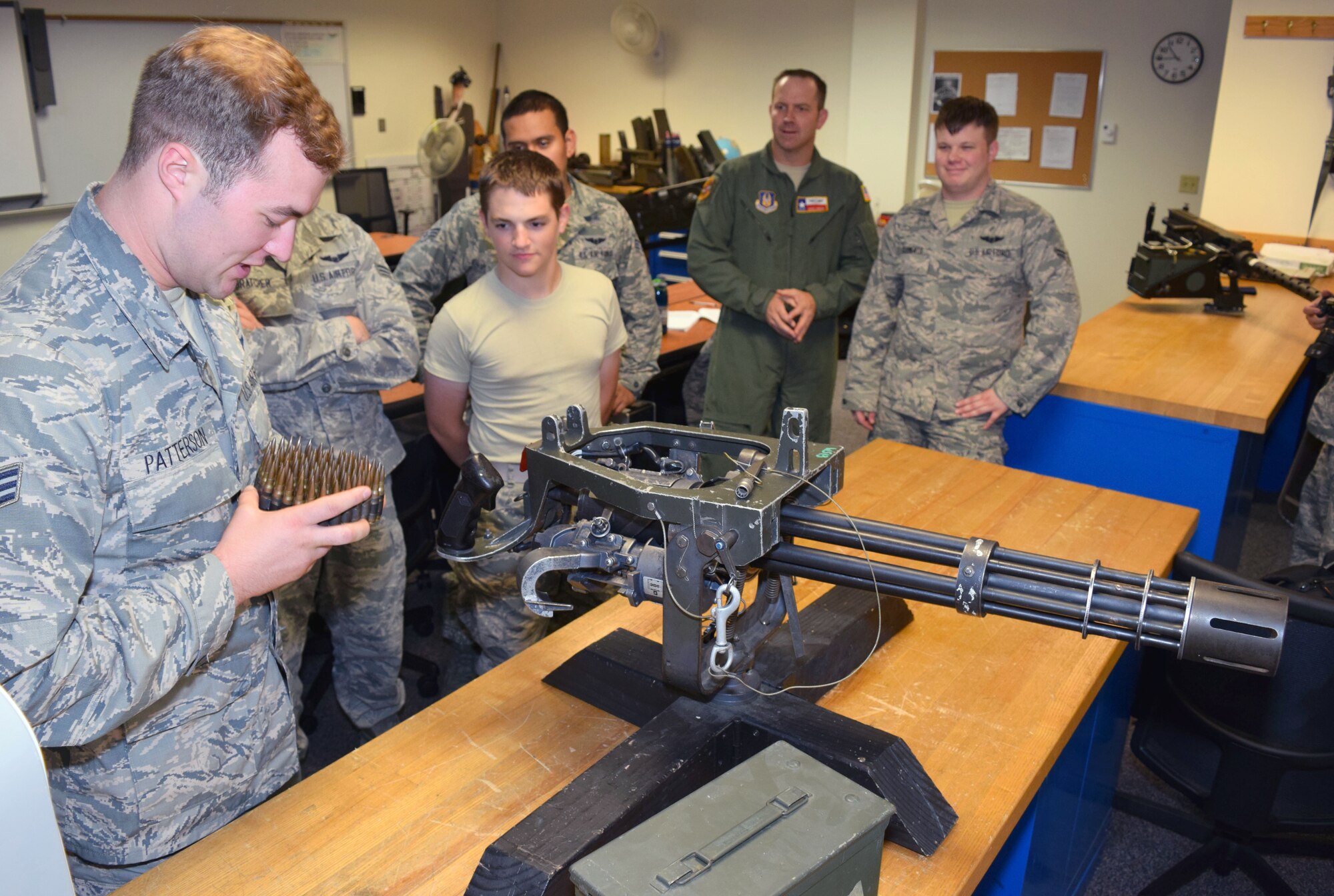 Senior Master Sgt. Marc Gibson, 433rd Training Squadron Career Enlisted Aviator Center of Excellence operations superintendent, quizzes Senior Airman Brandon Patterson, Special Missions Aviator course student, on the GAU-2C 7.62mm “Mini Gun” during a class break June 23, 2015 at the center based on Joint Base San Antonio-Lackland. Gibson is one of seven Reservists working alongside active duty Airmen at the Center of Excellence, which trains about 2,000 students in nine different aircrew specialties per year. (U.S. Air Force photo/Tech. Sgt. Lindsey Maurice)
