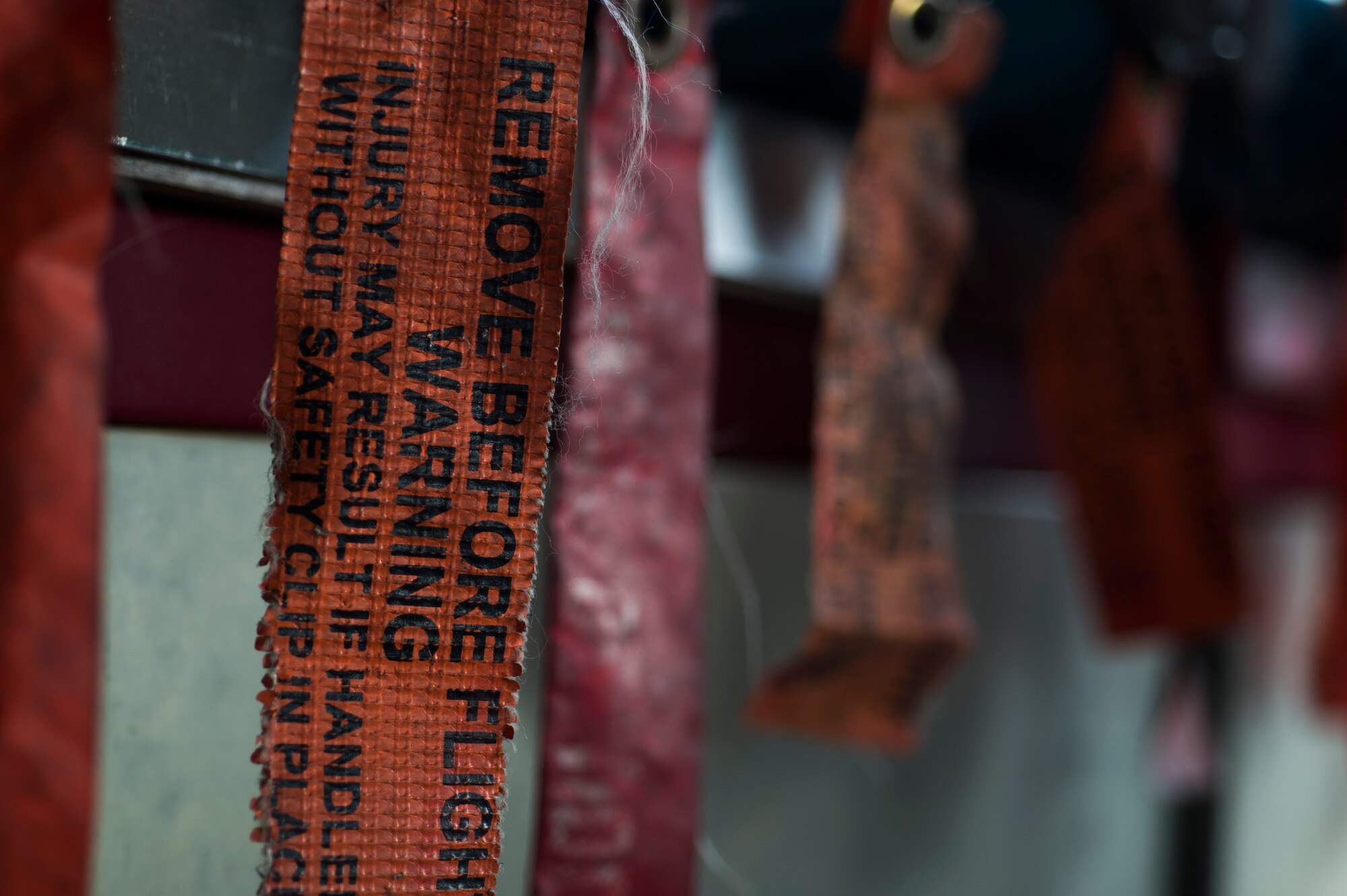Warning tags rest on a row of BDU-56 smurf bombs during a bomb load May 5, 2015, at Moody Air Force Base, Ga. The 23d Equipment Maintenance Squadron Munitions Flight prepares the bombs to ensure combat readiness to deploy aircraft assigned to Moody. (U.S. Air Force photo by Airman 1st Class Dillian Bamman/Released)