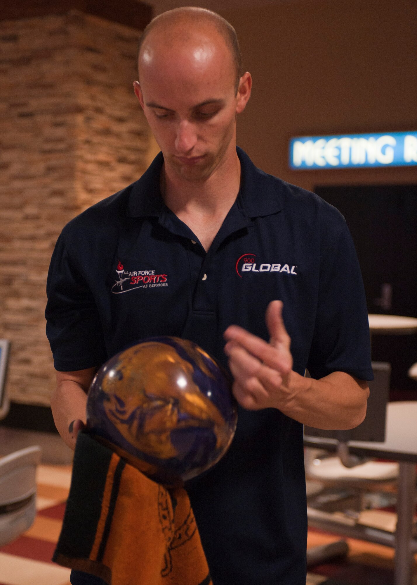 Staff Sgt. Joshua Cramer, 57th Maintenance Squadron munitions systems technician, wipes down his bowling ball before continuing his frame in Las Vegas, June 20,2015. Cramer started bowling when he was six years old, and is now on the U.S. Air Force bowling team. (U.S. Air Force photo by Airman 1st Class Mikaley Towle)