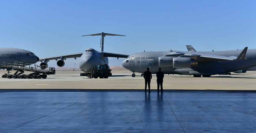 Colonel Joel Jackson, 60th Air Mobility Wing, commander, passes the quidon to Colonel Earl S. Scott who took control of the 60th Maintenance Group during his assumption of command ceremony held at hanger P-14, Travis AFB, June 22, 2015.  Jackson, who officiated the ceremony,  voiced his confidence in the new commander, lauding his previous accomplishments  (U.S. Air Force Photograph by Heide Couch/Released)