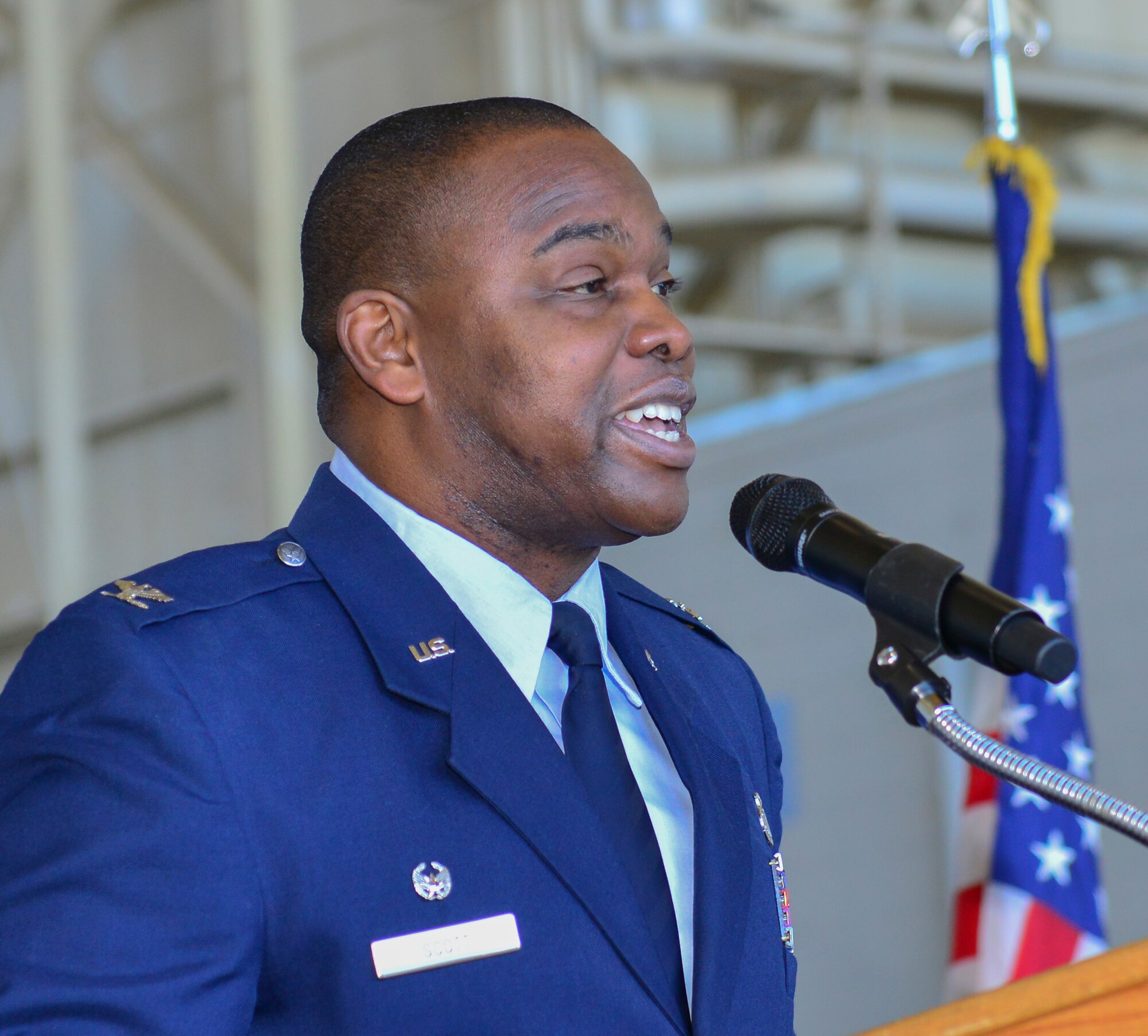 Colonel Joel Jackson, 60th Air Mobility Wing, commander, passes the quidon to Colonel Earl S. Scott who took control of the 60th Maintenance Group during his assumption of command ceremony held at hanger P-14, Travis AFB, June 22, 2015.  Jackson, who officiated the ceremony,  voiced his confidence in the new commander, lauding his previous accomplishments  (U.S. Air Force Photograph by Heide Couch/Released)