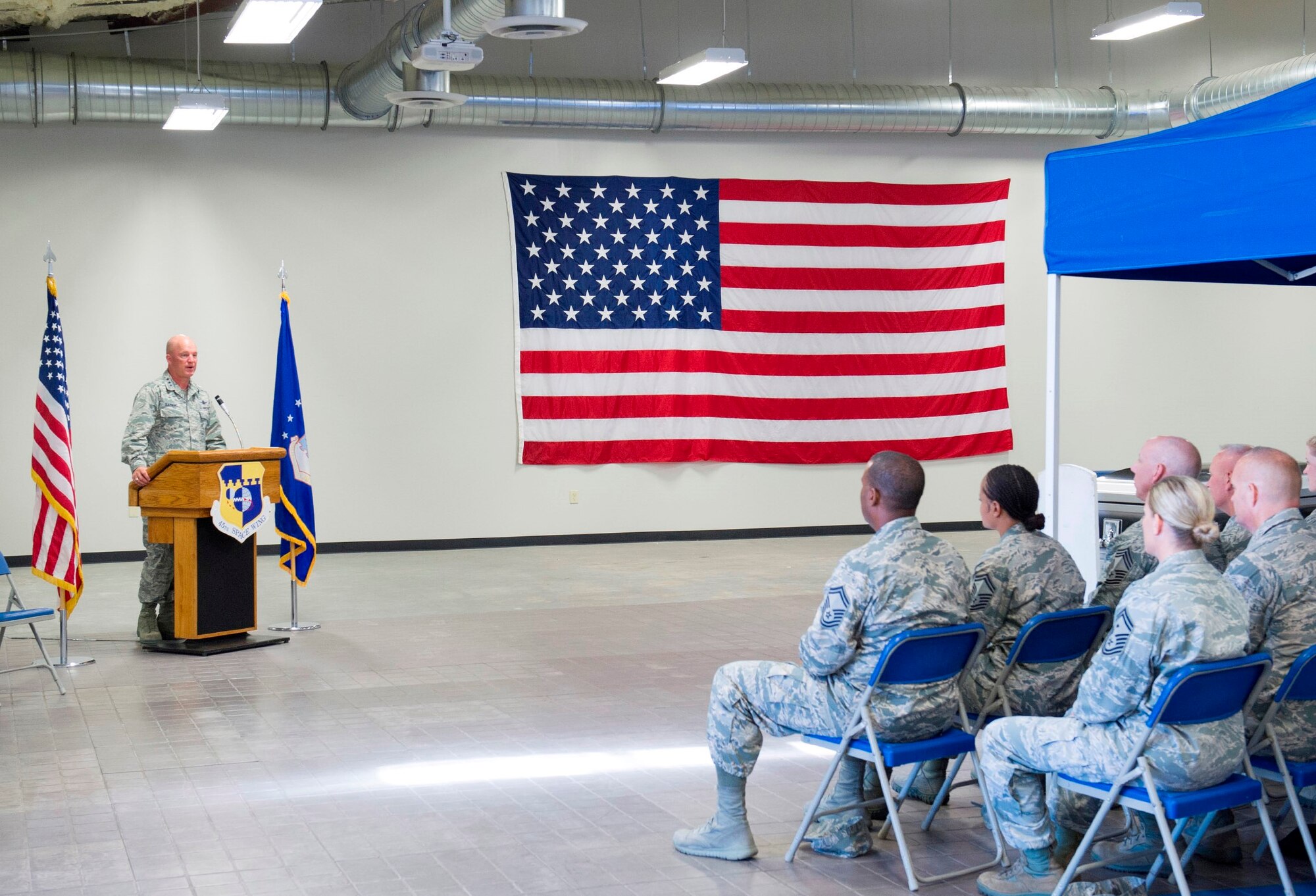 Lt. Gen. John Raymond, U.S. Strategic Command's Joint Functional Component Command for Space and 14th Air Force (Air Forces Strategic) commander, speaks to a crowd at the Patrick Air Force Base Honor Guard Demonstration at Patrick AFB, Fla., June 24, 2015. During Raymond’s one-day visit here, he visited several units, learned more about the 45th Space Wing’s Year of Connection, and interacted with Airmen from the wing. (U.S. Air Force photo/Matthew Jurgens) (Released)