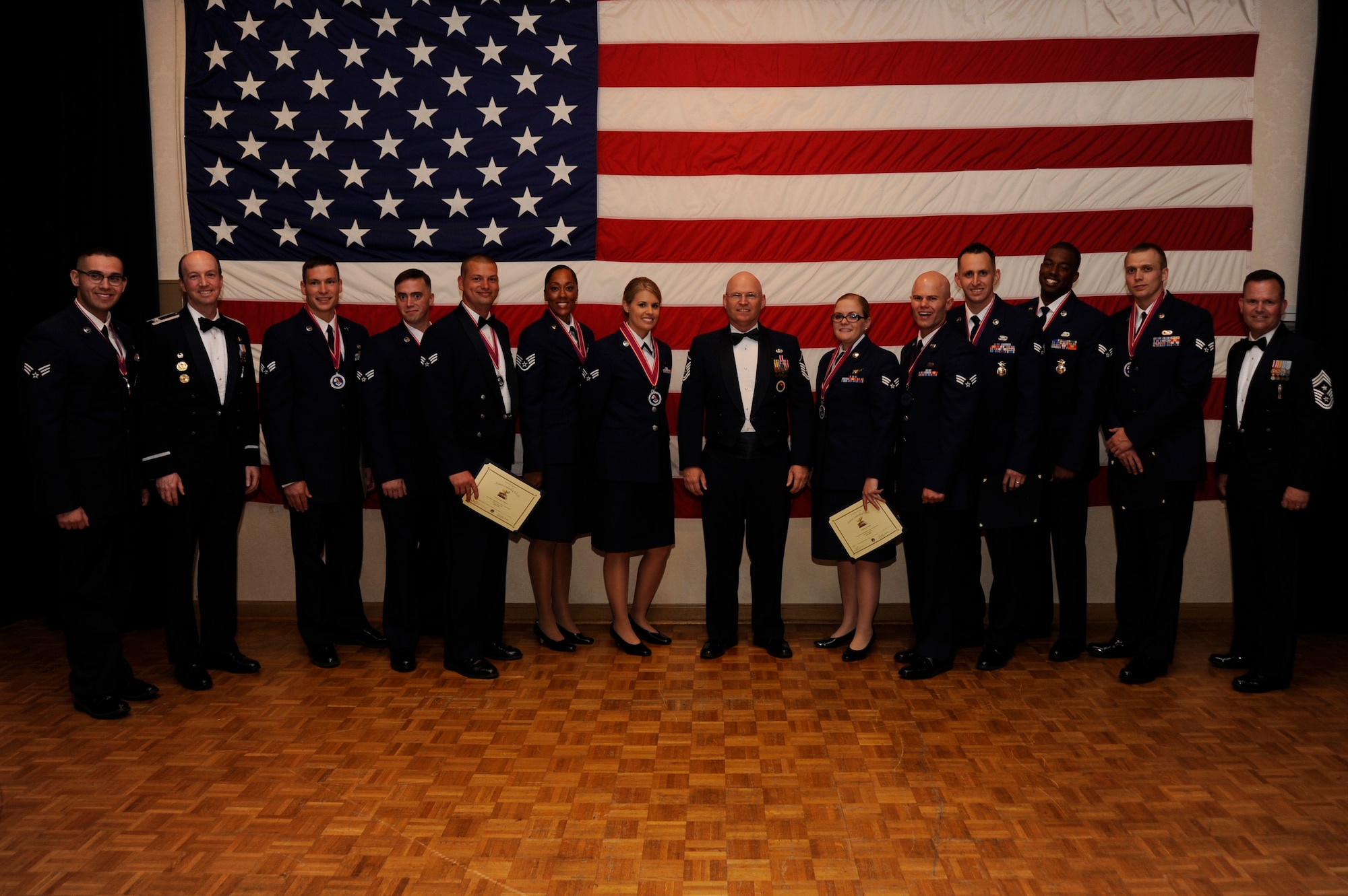 Members of Airman Leadership School, class 15-E, pose with members of base leadership after an ALS graduation, June 15, 2015, Vandenberg Air Force Base, Calif. The 12 students spent five weeks learning Air Force supervisory basics. (U.S. Air Force photo by Airman 1st Class Robert J. Volio /Released)