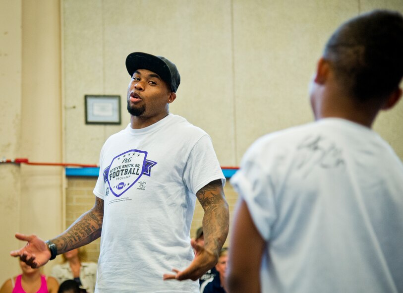 Baltimore Ravens’ wide receiver, Steve Smith, answers questions from attendees during the two-day children’s football camp June 24 at Eglin Air Force Base, Fla.  Smith was the professional coach at the camp that taught the kids up-tempo football drills, exercises and scrimmages. Approximately 150 children attended the camp which was made possible because the Eglin Commissary won a Proctor and Gamble sales contest. (U.S. Air Force photo/Samuel King Jr.)