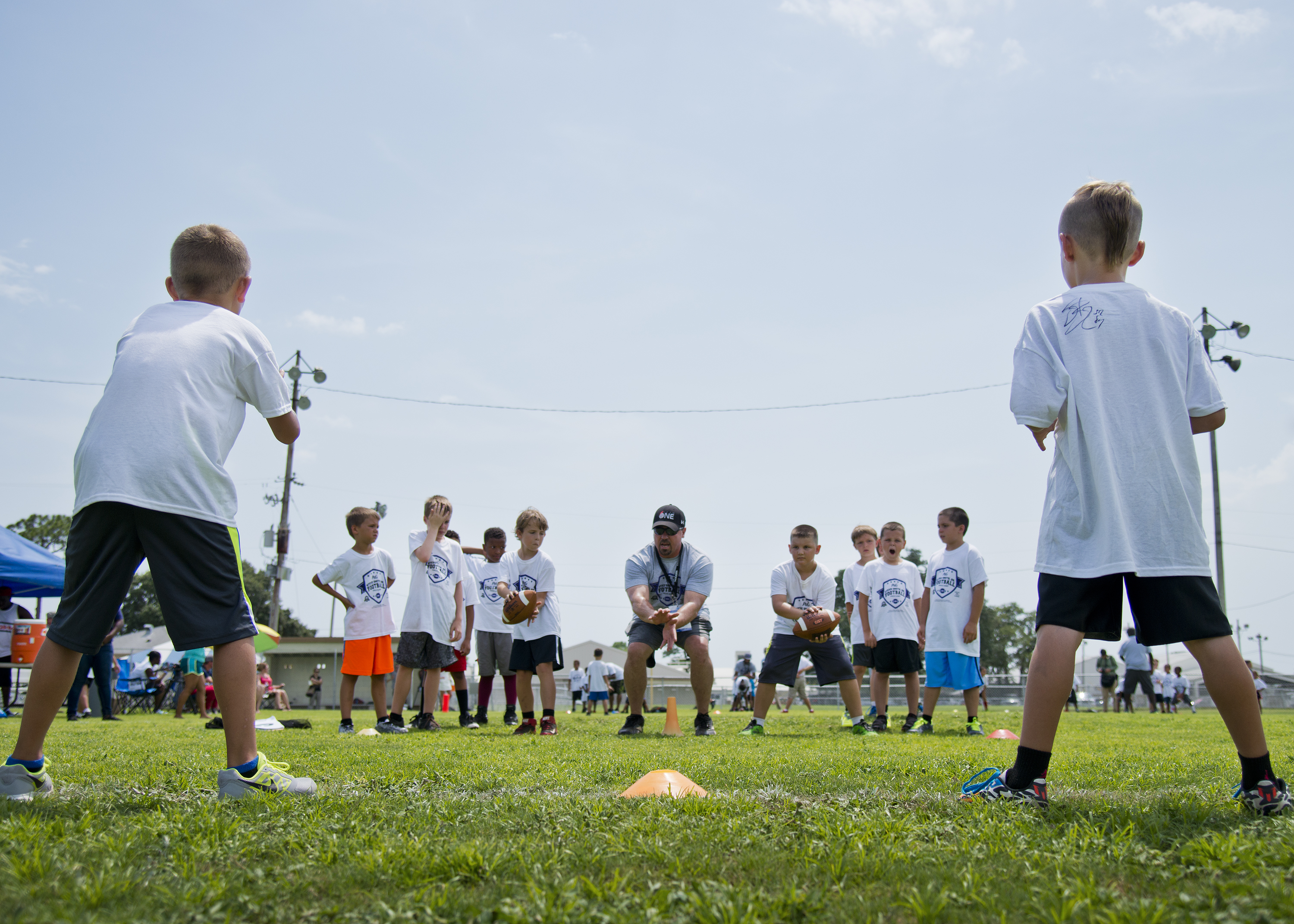 Little Athletes Learn From Pros At Football Camp