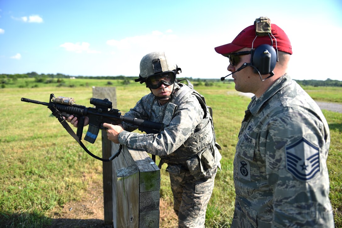 Commander of the 932nd Airlift Wing, Col. Karl Goerke, listens to range instructions before aiming a rifle downrange.  Airmen with the 932nd Airlift Wing Security Forces Squadron (SFS) participated in various skills training during a field condition exercise in June near the Sparta Shooting Complex, Sparta Ill. The training was during annual tour for most reservists, and included perimeter sweeps, securing the wooded outpost, and a variety of patrols which led to a simulated encounter with enemy forces. (U.S. Air Force photo/Tech. Sgt. Christopher Parr)