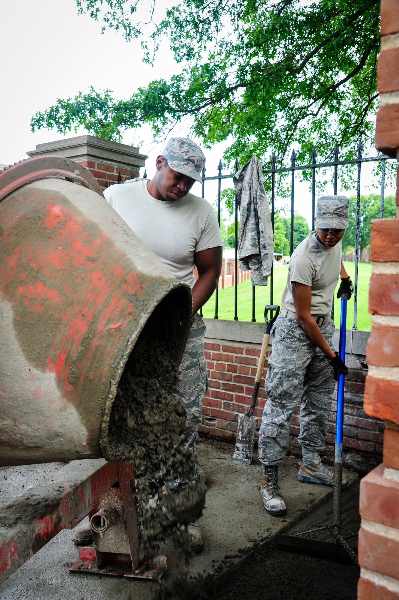 Staff Sgt. Keenan Willis, Heavy Equipment Operator and Airman 1st Class Sierra Murphy, Structural Craftsman, 113th Civil Engineer Squadron, repair a section of sidewalk near the entrance of the U.S. Coast Guard Academy while on a deployment for training.  (U.S. Air National Guard photo by Chief Master Sgt. Andrew Baker)