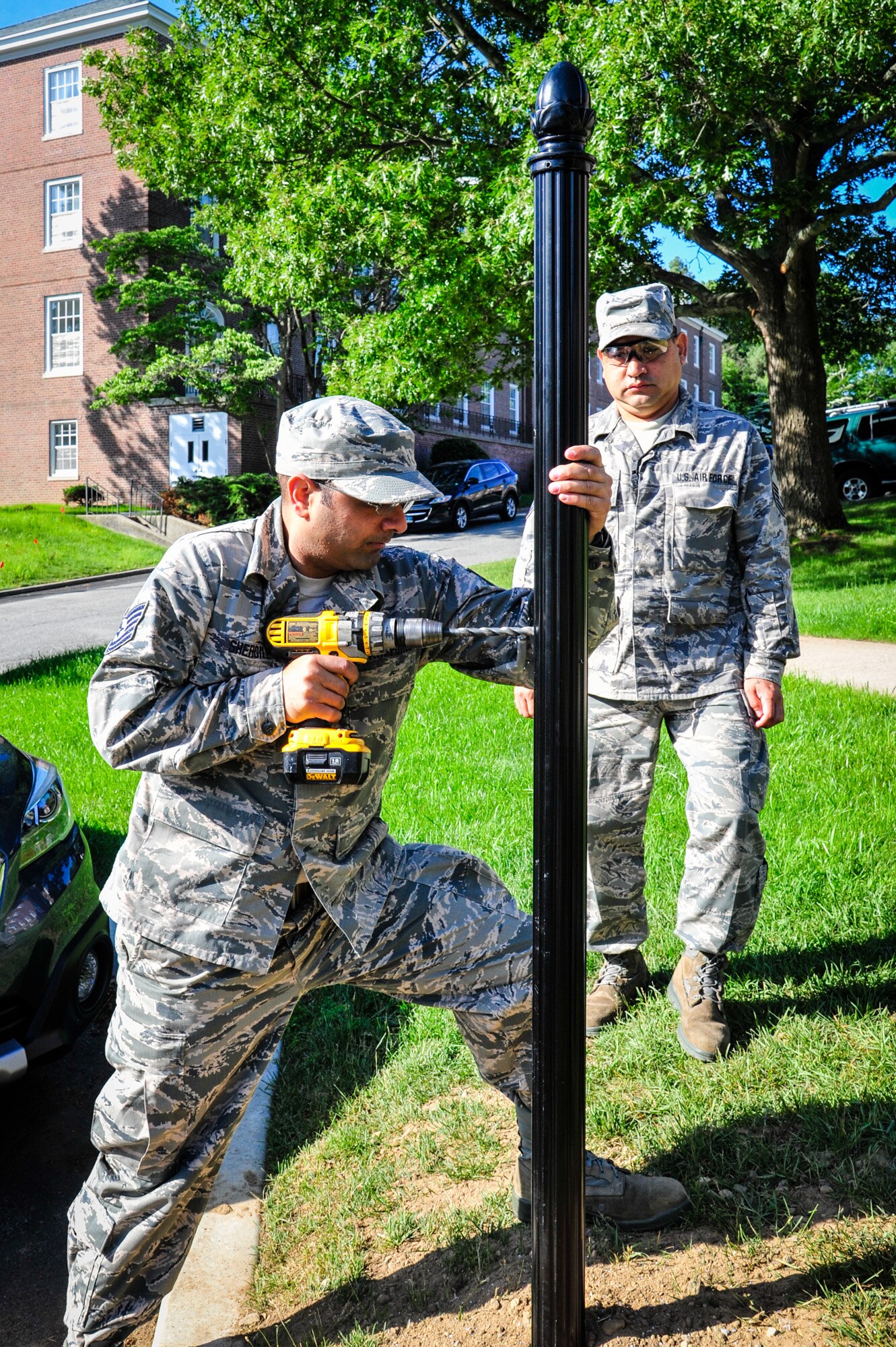 113th Civil Engineer Squadron Engineering Assistant Tech. Sgt. Gursimran Shergill and Operations Manager Master Sgt. Cruz Velez install new signposts while deployed for training to the U.S. Coast Guard Academy.  (U.S. Air National Guard photo by Chief Master Sgt. Andrew Baker)