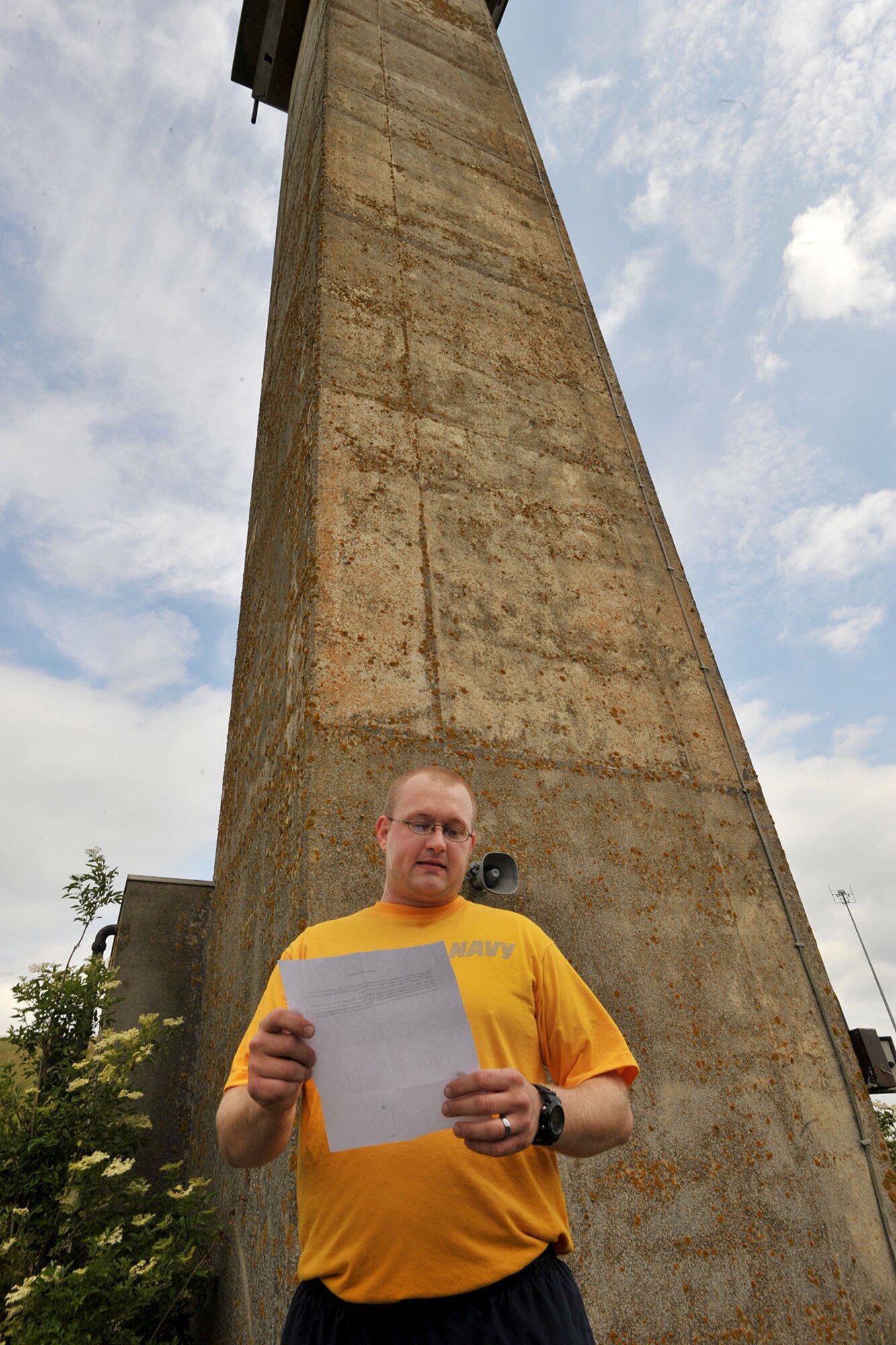 U.S. Navy Petty Officer 1st Class Andrew, U.S. Africa Command analyst, recites the history of the U.S. Air Force's mobile nuclear armed Ground Launched Cruise Missiles area, which consisted of bunkers and a watchtower, during a heritage run at RAF Molesworth, United Kingdom, June 19th, 2015. The run, conducted by the Chief Petty Officer 365, consisted of the history of Molesworth, instead of the typical Navy heritage, due to the joint environment. (U.S. Air Force photo by Staff Sgt. Ashley Hawkins/Released) (Last names were removed for security purposes)