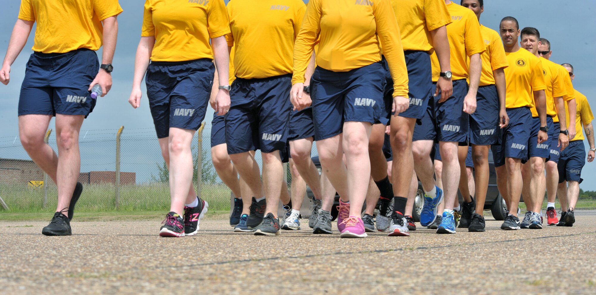 U.S. Navy personnel assigned to the U.S. European Command, Joint Intelligence Operations Center, Europe Analytic Center and the U.S. Africa Command begin marching during a heritage run at RAF Molesworth, United Kingdom, June 19, 2015. The run was conducted by the Chief Petty Officer 365, a Navy-wide, year-long program dedicated to preparing board-eligible first classes to become future chiefs. (U.S. Air Force photo by Staff Sgt. Ashley Hawkins/Released)