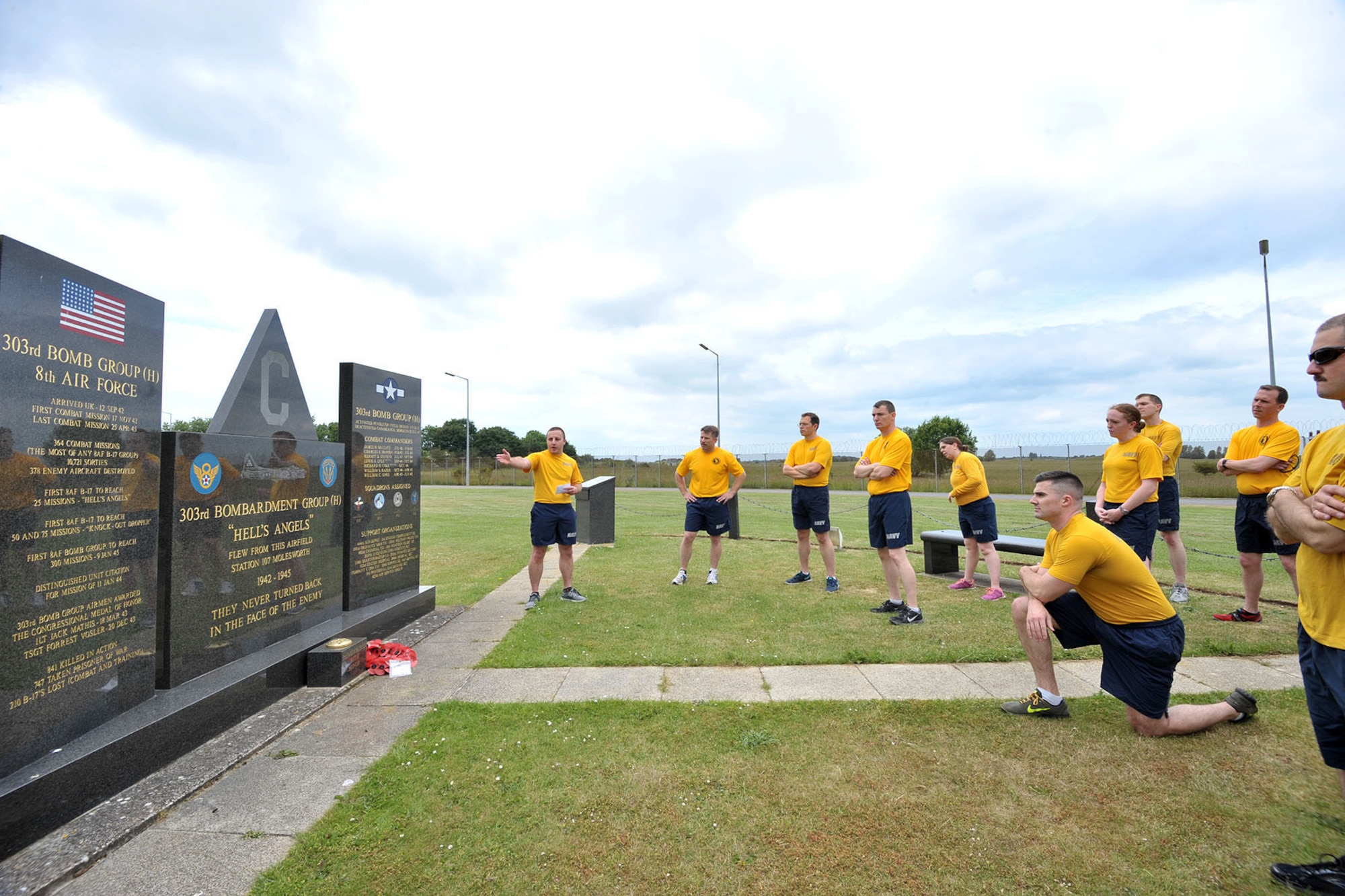 U.S. Petty Officer 1st Class Paul, U.S. Africa Command analyst, explains the history of the 303rd Bombardment Group during a heritage run at RAF Molesworth, June 19, 2015. Participants of the run, conducted by the Chief Petty Officer 365 program, stopped at various "stations" around the base to learn about the heritage of Molesworth. (U.S. Air Force photo by Staff Sgt. Ashley Hawkins/Released) (Last names were removed for security purposes)