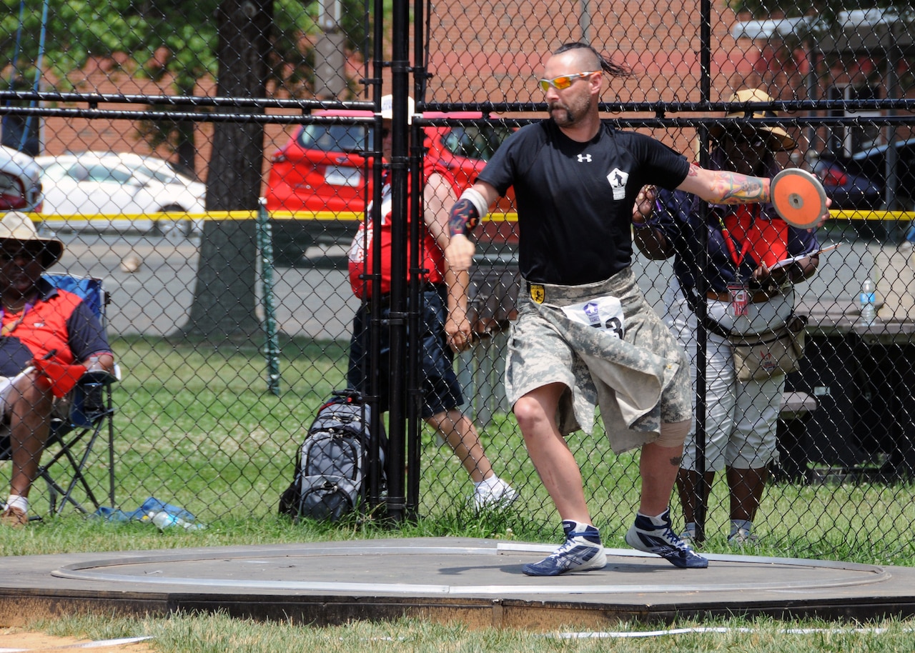 Army veteran Andy McCaffrey competes in the men's standing 5.0 discus division during the 2015 DoD Warrior Games at Marine Corps Base Quantico, Va., June 23, 2015. McCaffrey wears his tartan to all of his events to show his Irish and Army pride. DoD photo by Shannon Collins