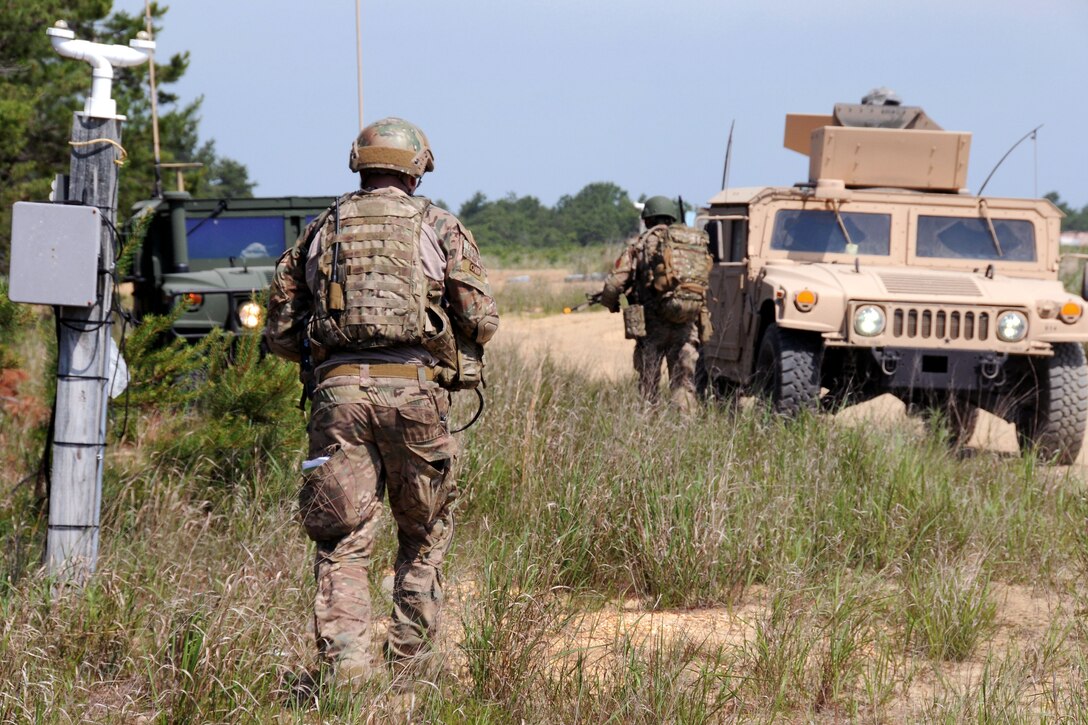 Airmen return to their Humvee after conducting several missions during Operation Morning Coffee at Warren Grove Gunnery Range, N.J., June 16, 2015. 