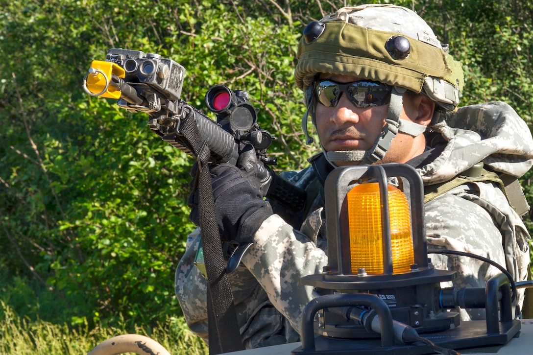 Army Sgt. 1st Class Gene Ruiz provides security during a convoy mission part of Patriot Warrior on Fort McCoy, Wis., June 16, 2015. Ruiz is assigned to the 46th Chemical Company. Patriot Warrior is a joint exercise designed to demonstrate contingency deployment training ranging from bare base buildup to full operational capabilities. 