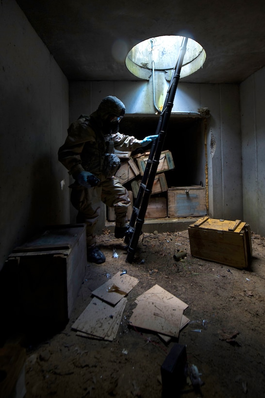 Army Staff Sgt. Michael Aldrich enters a tunnel system during chemical ...