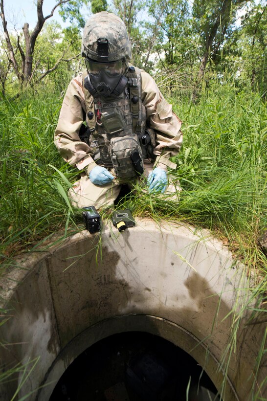 Army Staff Sgt. Michael Aldrich inspects a manhole leading to a tunnel system during chemical, biological, radiological, nuclear, and explosive training as part of Patriot Warrior at Fort McCoy, Wis., June 16, 2015. Aldrich is assigned to the 46th Chemical Company.