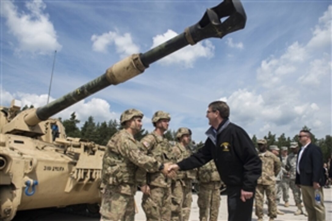U.S. Defense Secretary Ash Carter shakes hands with crew members as he receives a tour of a static M109A6 self-propelled howitzer at the Grafenwoehr Training Area in Grafenwoehr, Germany, June 26, 2015. During his European trip, Carter also attended his first NATO ministerial in Brussels as defense secretary.