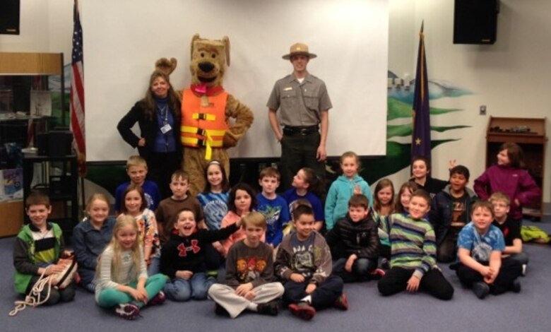 Cole Van Beusekom (left), park ranger at the Chena Project, conducts water safety education programs at local schools with his trusty sidekick, Bobber the Water Safety Dog.
