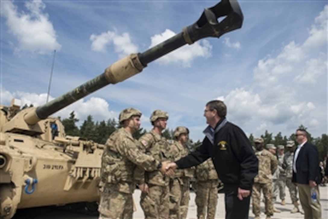 U.S. Defense Secretary Ash Carter shakes hands with crew members as he receives a tour of a static M109A6 self-propelled howitzer at the Grafenwoehr Training Area in Grafenwoehr, Germany, June 26, 2015. During his European trip, Carter also attended his first NATO ministerial in Brussels as defense secretary.