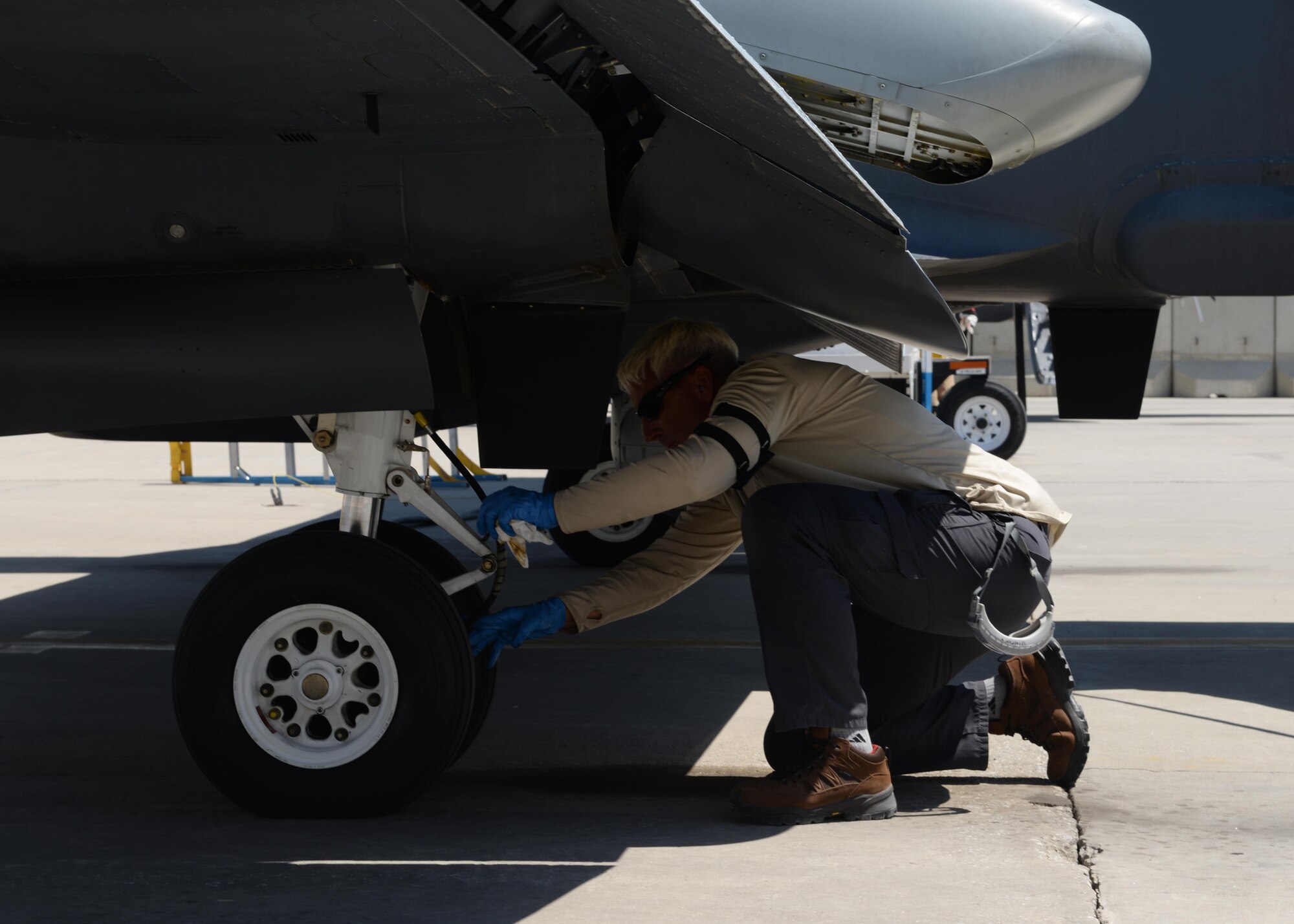 Jeffery Hinchey, 455th Expeditionary Aircraft Maintenance Squadron aircraft mechanic, checks the tires of an MC-12W June 26, 2015, at Bagram, Airfield, Afghanistan. Hinchey is part of the Project Liberty team that is deployed here in support of NATO’s Resolute Support mission. (U.S. Air Force photo by Senior Airman Cierra Presentado/Released)