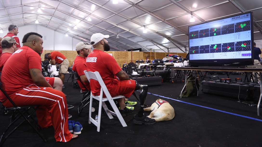 Members of the All-Marine Team review competitor results during the 2015 Department of Defense (DoD) Warrior Games shooting competition at Marine Corps Base (MCB) Quantico, Virginia, June 26, 2015. The 2015 DoD Warrior Games, held at MCB Quantico June 19-28, is an adaptive sports competition for wounded, ill, and injured Service members and veterans from the U.S. Army, Marine Corps, Navy, Air Force, Special Operations Command, and the British Armed Forces. 
