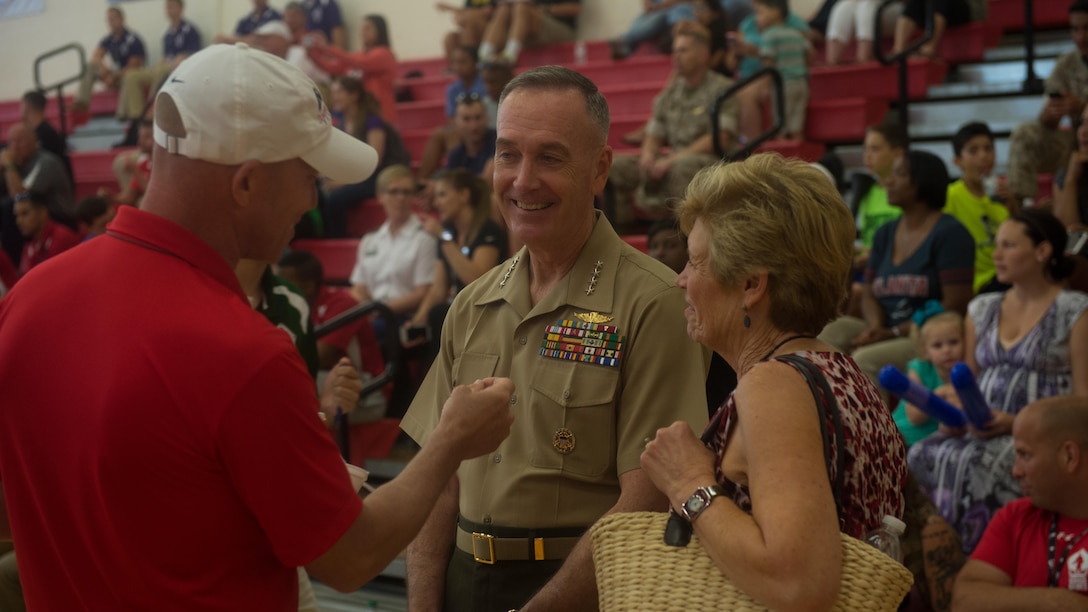 U.S. Marine Corps Commandant Gen. Joseph Dunford and his wife speak to service members during the 2015 Department of Defense Warrior Games Sitting Volleyball event at Marine Corps Base Quantico, Virginia, June 19-28, 2015. The Warrior Games, founded in 2010, is a Paralympic-style competition that features eight adaptive sports for wounded, ill, and injured service members and veterans from the U.S. Army, Marine Corp, Navy/Coast Guard, Air Force, Special Operations Command, and the British Armed Forces. This year marks the first time the DoD takes responsibility for operational planning and coordination of the event, in which approximately 250 athletes are expected to compete. 