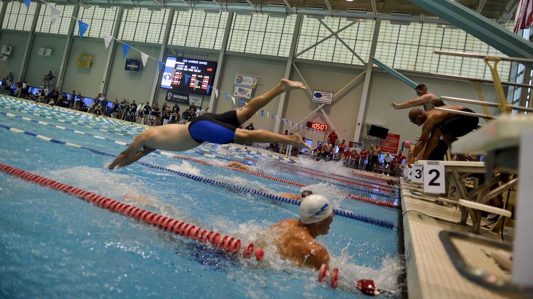 Teams with the 2015 Department of Defense Warrior Games conduct the relay portion of the swimming competition at Freedom Aquatics, Manassas, Virginia, June 27, 2015. The Warrior Games, founded in 2010, is a Paralympic-style competition that features eight adaptive sports for wounded, ill, and injured service members and veterans from the U.S. Army, Marine Corps, Navy/Coast Guard, Air Force, Special Operations Command, and the British Armed Forces. This year marks the first time the DoD takes responsibility for operational planning and coordination of the event, in which approximately 250 athletes are expected to compete.