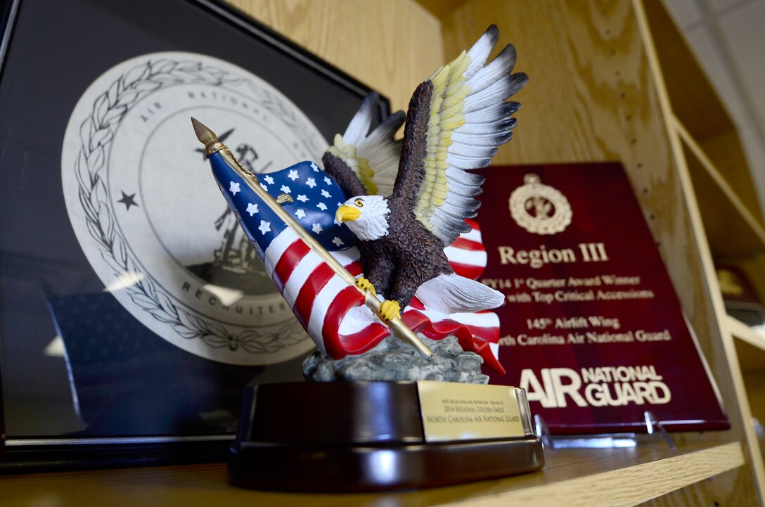 The Regional Golden Eagle Award sits prominently on the shelf of the 145th Force Support Squadron recruiting and retention office located on the North Carolina Air National Guard base, Charlotte Douglas International Airport, N.C., June 16, 2015. The recruiters earned the award for top performance in 2014, as well as seven individual awards. During a ceremony held on June 7, 2015, Brig. Gen. Roger E. Williams, Jr., Assistant Adjutant General for Air, North Carolina Air National Guard, presented the awards. (U.S. Air National Guard photo by Staff Sgt. Julianne M. Showalter, 145th Public Affairs/Released)