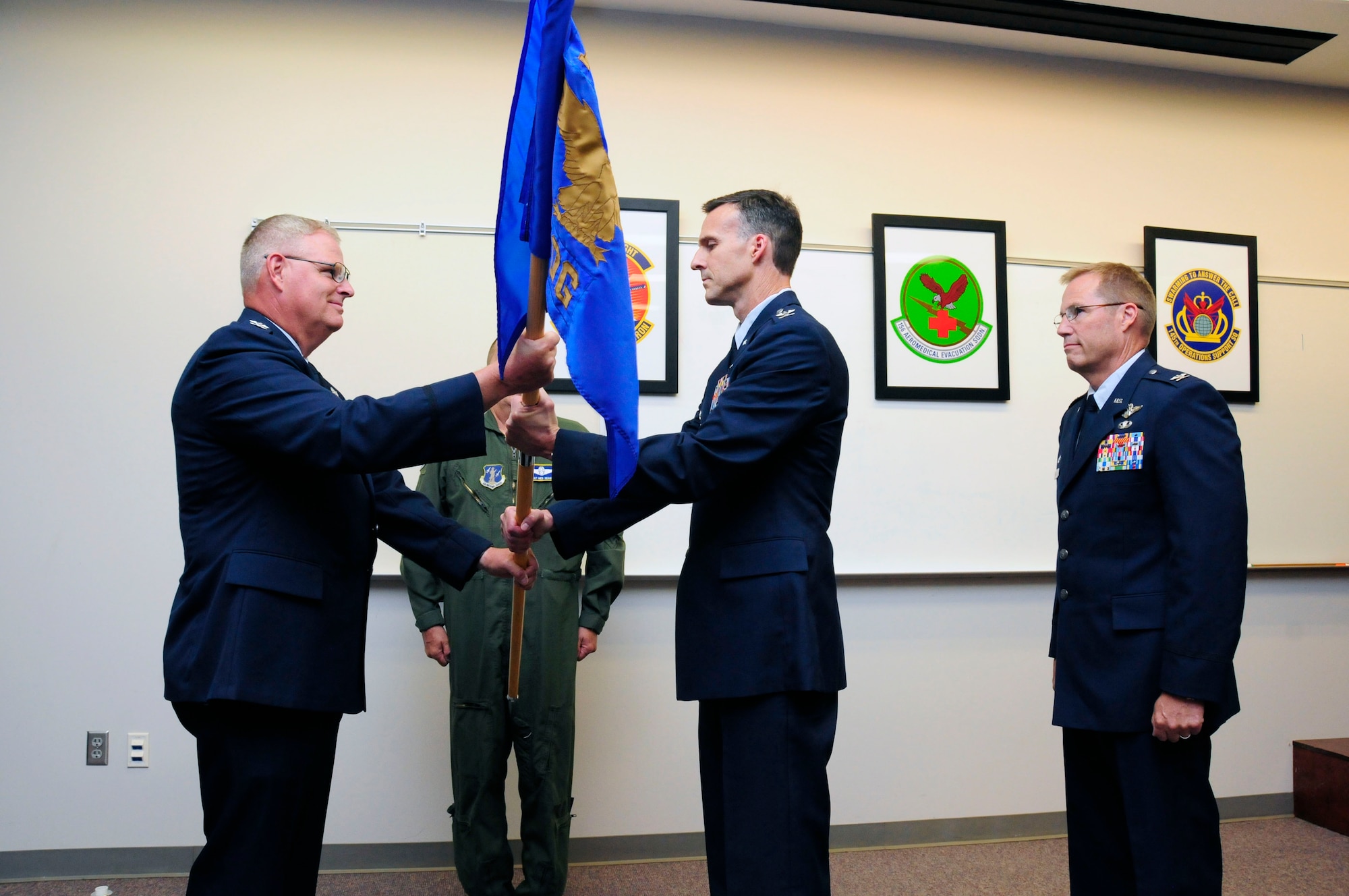 U.S. Air Force Col. Joseph H. Stepp IV, assumes command of the 145th Operations Group as he accepts the 145th OG guidon from Col. Marshall C. Collins, commander, 145th Airlift Wing, during a change of command ceremony held at the North Carolina Air National Guard Base, Charlotte Douglas International Airport; June 6, 2015. (U.S. Air National Guard photo by Master Sgt. Patricia F. Moran, 145th Public Affairs/Released)