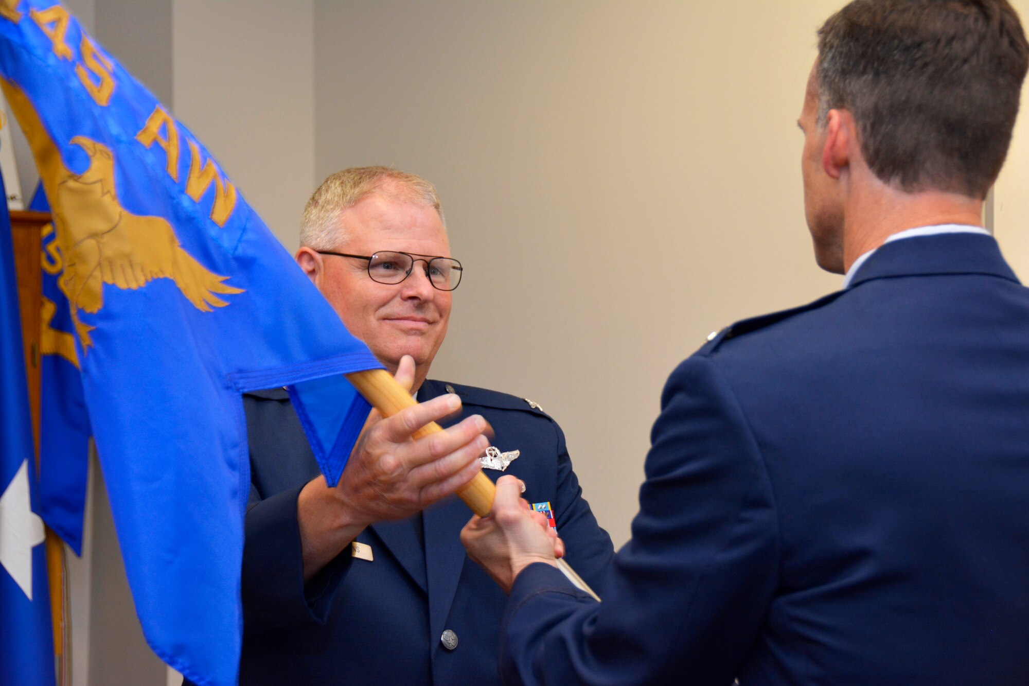 U.S. Air Force Col. Joseph H. Stepp IV, assumes command of the 145th Operations Group as he accepts the 145th OG guidon from Col. Marshall C. Collins, commander, 145th Airlift Wing, during a change of command ceremony held at the North Carolina Air National Guard Base, Charlotte Douglas International Airport; June 6, 2015. (U.S. Air National Guard photo by Senior Airman Laura Montgomery, 145th Public Affairs/Released)