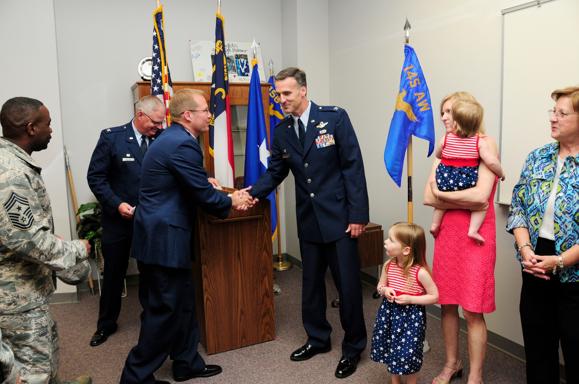 U.S. Air Force Col. Charles D. Davis III congratulates Col. Joseph H. Stepp IV, commander, 145th Operations Group, after Stepp’s promotion ceremony held at the North Carolina Air National Guard Base, Charlotte Douglas International Airport; June 6, 2015. (U.S. Air National Guard photo by Master Sgt. Patricia F. Moran, 145th Public Affairs/Released)