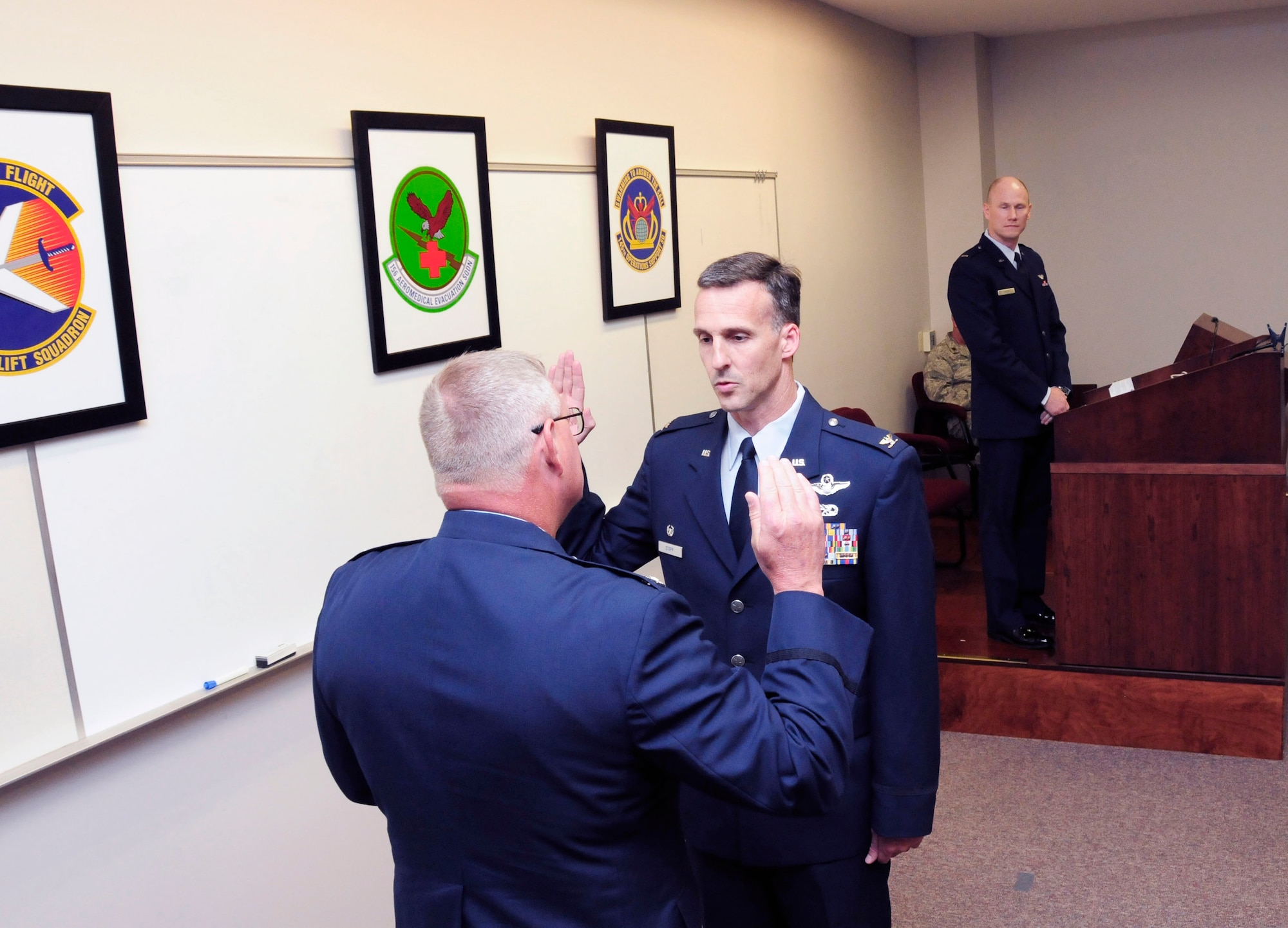 U.S. Air Force Col. Marshall C. Collins, commander, 145th Airlift Wing, officiates over a promotion ceremony held at the North Carolina Air National Guard Base, Charlotte Douglas International Airport, as Col. Joseph H. Stepp IV, recites the oath of office following his pinning to the rank of Colonel, June, 6, 2015. (U.S. Air National Guard photo by Master Sgt. Patricia F. Moran, 145th Public Affairs/Released)