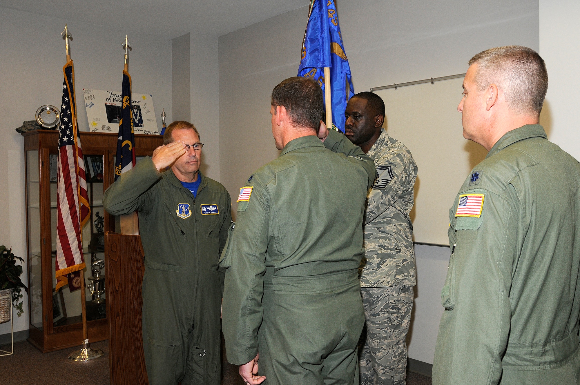 U.S. Air Force Lt. Col. Miles K. Harkey relinquishes command of the 145th Operations Support Squadron and assumes command of the 156th Airlift Squadron, June 6, 2015. Col. Charles D. Davis III, commander, 145th Operations Group officiated the change of command ceremony held at the North Carolina Air National Guard Base, Charlotte Douglas International Airport. (U.S. Air National Guard photo by Senior Airman Laura Montgomery, 145th Public Affairs/Released)