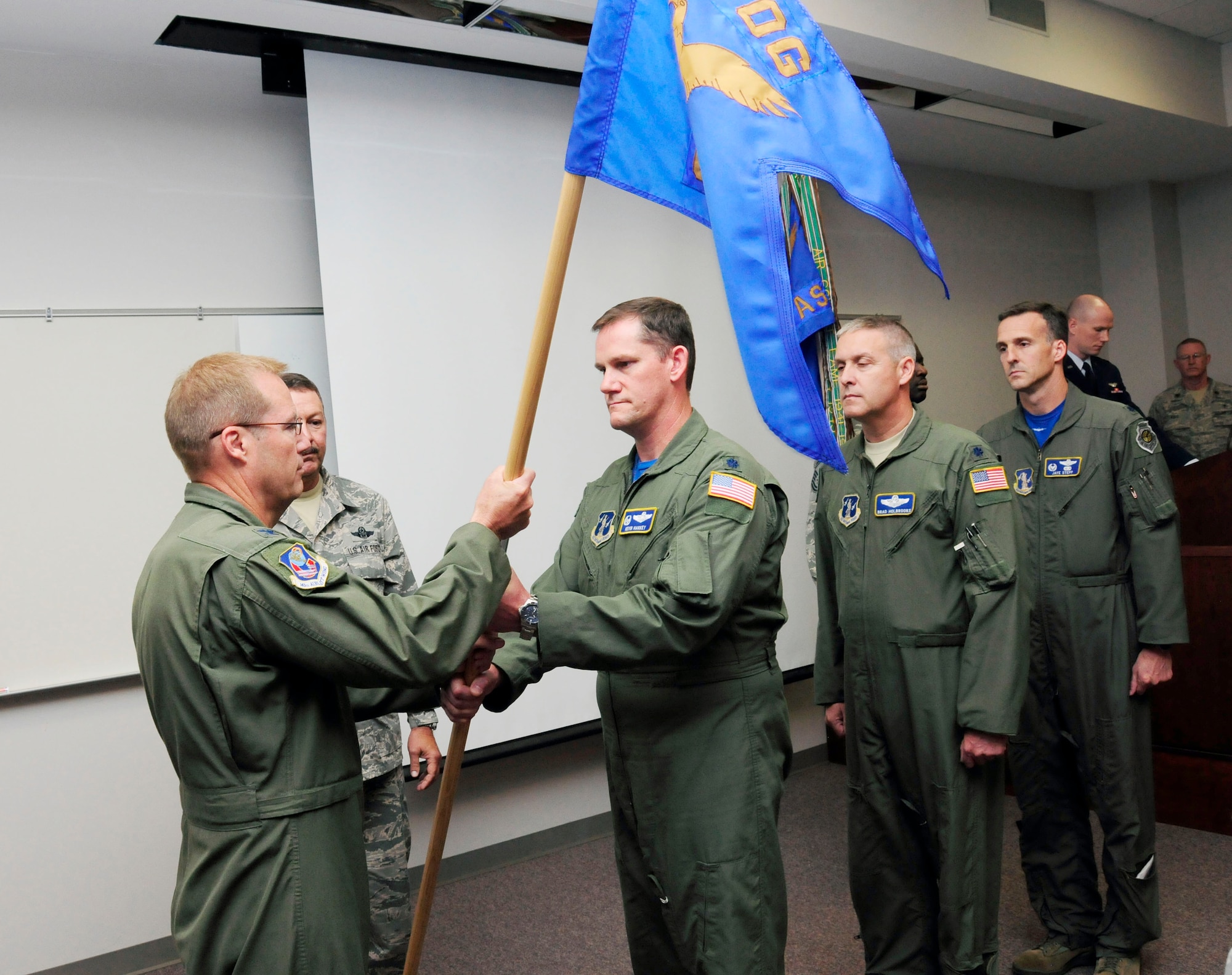 During a change of command ceremony officiated by U.S. Air Force Col. Charles D. Davis III, commander, 145th Operations Group, Lt. Col. Miles K. Harkey relinquishes command of the 145th Operations Support Squadron and assumes command of the 156th Airlift Squadron. The ceremony was held at the North Carolina Air National Guard Base, Charlotte Douglas International Airport; June 6, 2015. (U.S. Air National Guard photo by Master Sgt. Patricia F. Moran, 145th Public Affairs/Released)