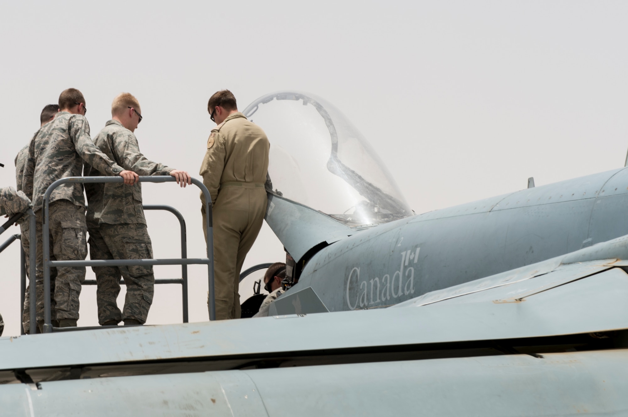 U.S. Air Force Academy cadets check out a Royal Canadian Air Force CF-18 Hornet during a visit to an undisclosed location in Southwest Asia, June 22, 2015. This visit reinforced the commitment and strengthened existing relationships with coalition partners while motivating future U.S. leaders. (Courtesy photo from Canadian Air Task Force-Iraq Public Affairs)