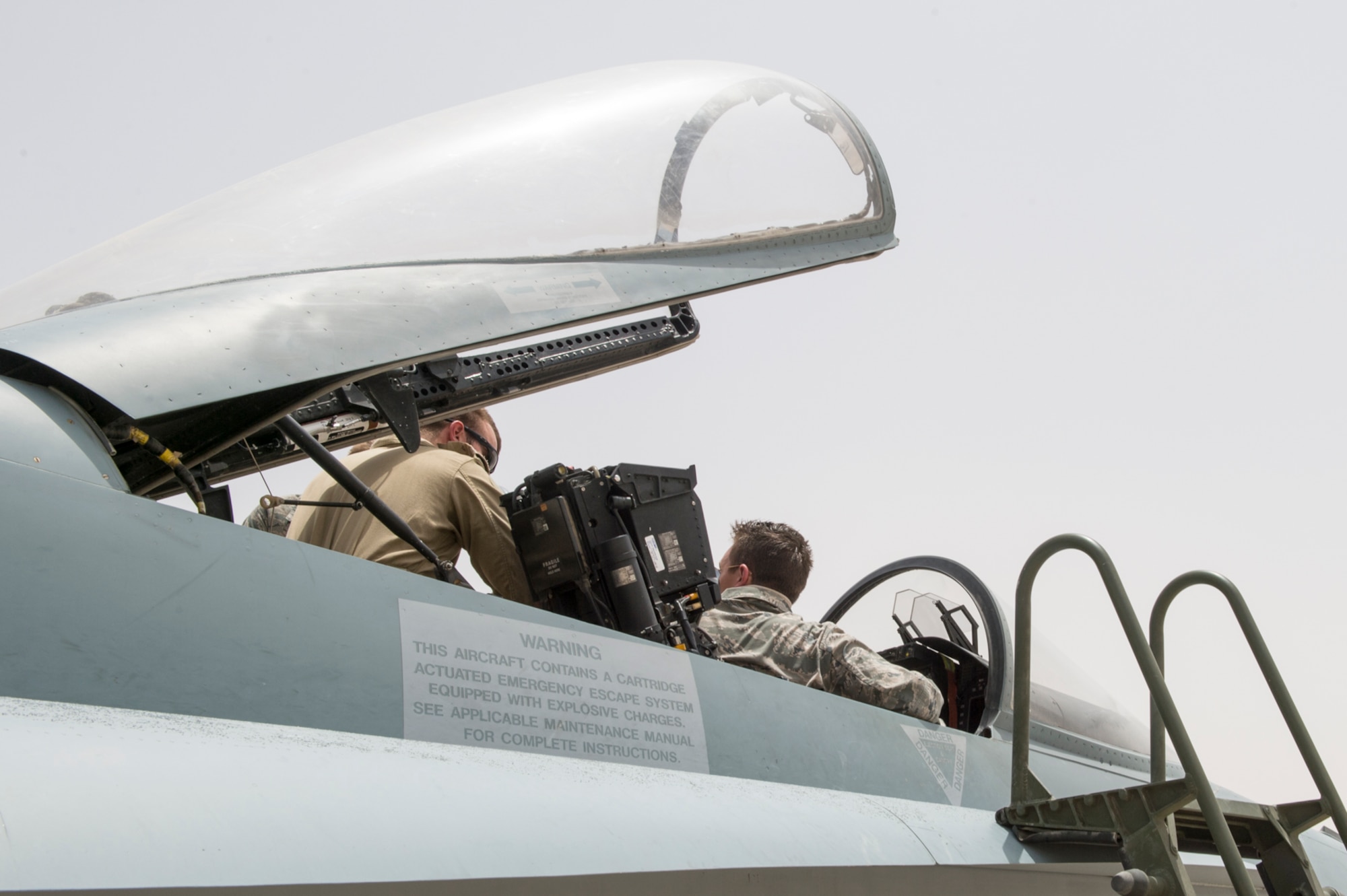 U.S. Air Force Academy cadets sit in a Royal Canadian Air Force CF-18 Hornet during a visit to an undisclosed location in Southwest Asia, June 22, 2015. Cadets experienced the relationships and mission capabilities between coalition forces and the important role it plays. (Courtesy photo from Canadian Air Task Force-Iraq Public Affairs)