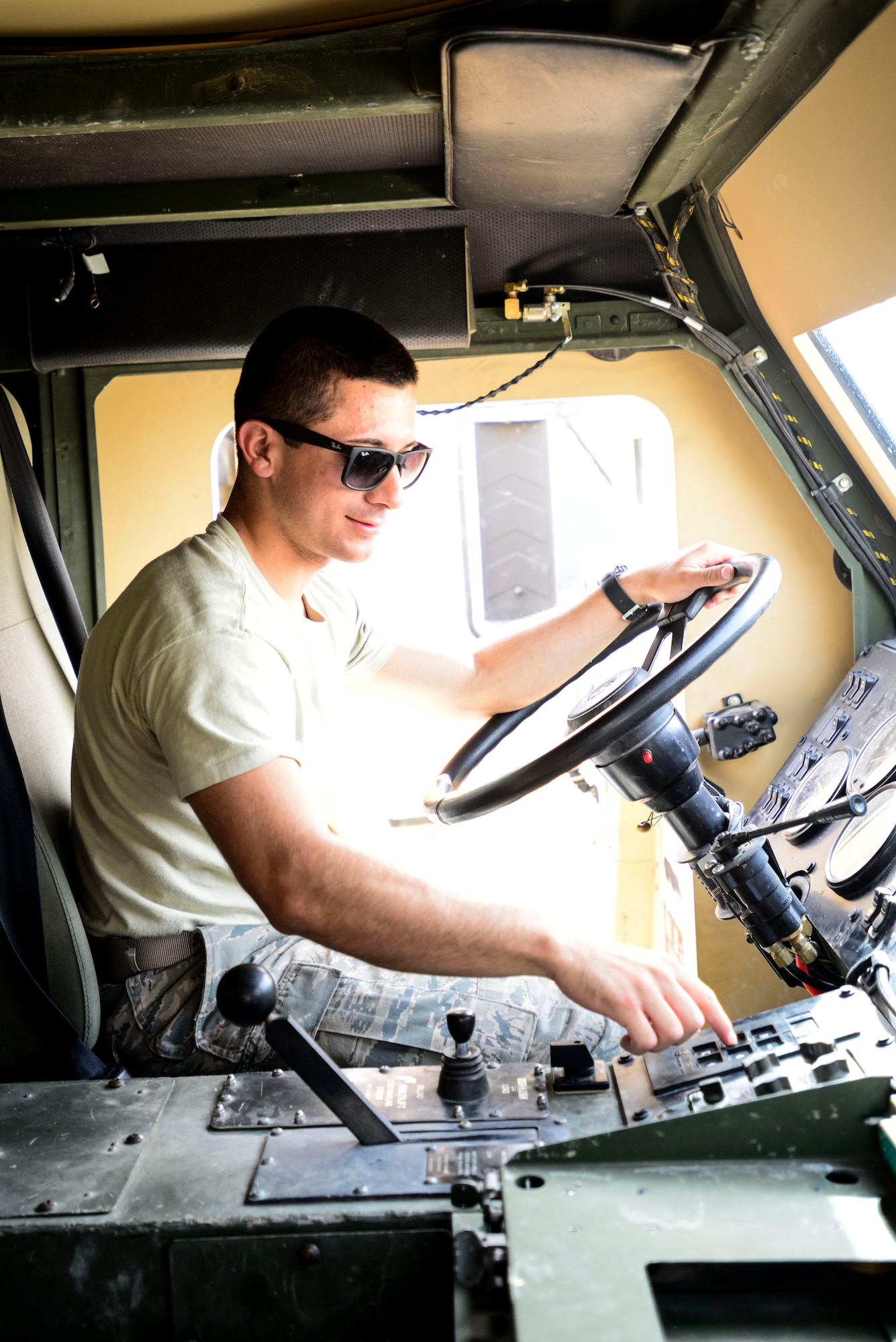 Cadet Kyle Post checks out the controls to a Logistics Vehicle System Replacement during a visit to an undisclosed location in South West Asia, June 10, 2015. Cadets from the U.S. Air Force Academy participated in a graduation-requirement summer program called Operation Air Force, which gave students on-the-job experience for their future careers. (U.S. Air Force photo by Senior Airman Racheal E. Watson/Released)