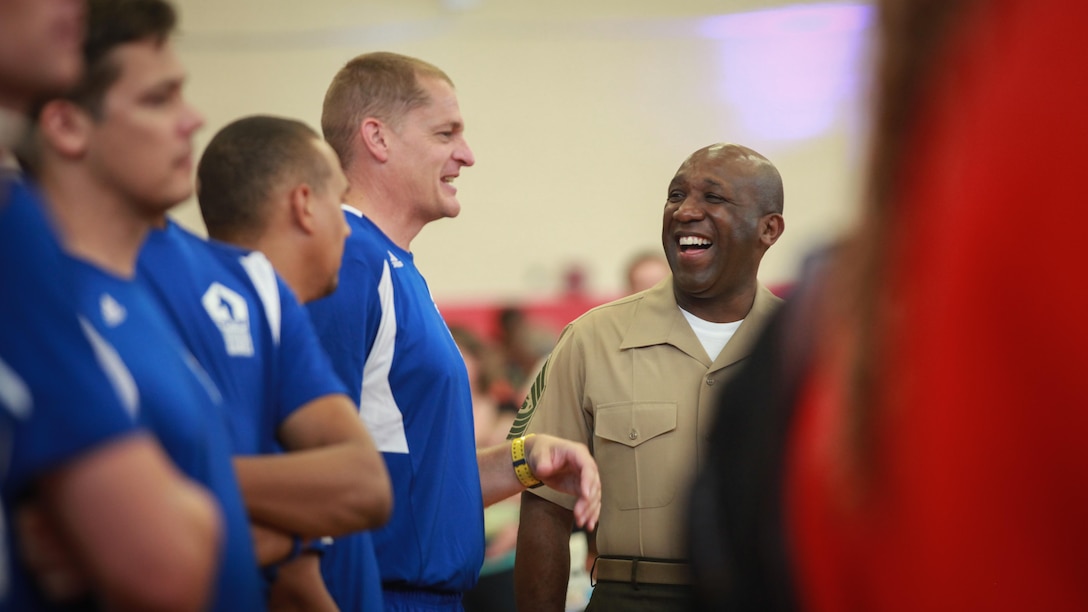 Sgt. Maj. Ronald L. Green, the 18th Sergeant Major of the Marine Corps, presents medals to the Marine Corps Sitting Volleyball Team during the Department of Defense Warrior Games at Marine Corps Base Quantico, Virginia, June 28, 2015. 