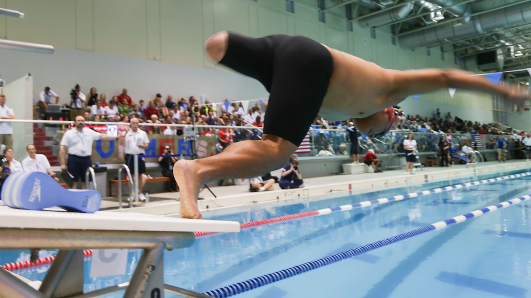 U.S. Marine Corps Cpl. Marcus Chischilly takes off during the swimming finals at the Freedom Aquatic and Fitness Center in Manassas, Virginia, June 27, 2015. Chischilly is a member of the 2015 Department of Defense (DoD) Warrior Games All-Marine Team. The 2015 DoD Warrior Games, held at Marine Corps Base Quantico June 19-28, is an adaptive sports competition for wounded, ill, and injured Service members and veterans from the U.S. Army, Marine Corps, Navy, Air Force, Special Operations Command, and the British Armed Forces. 