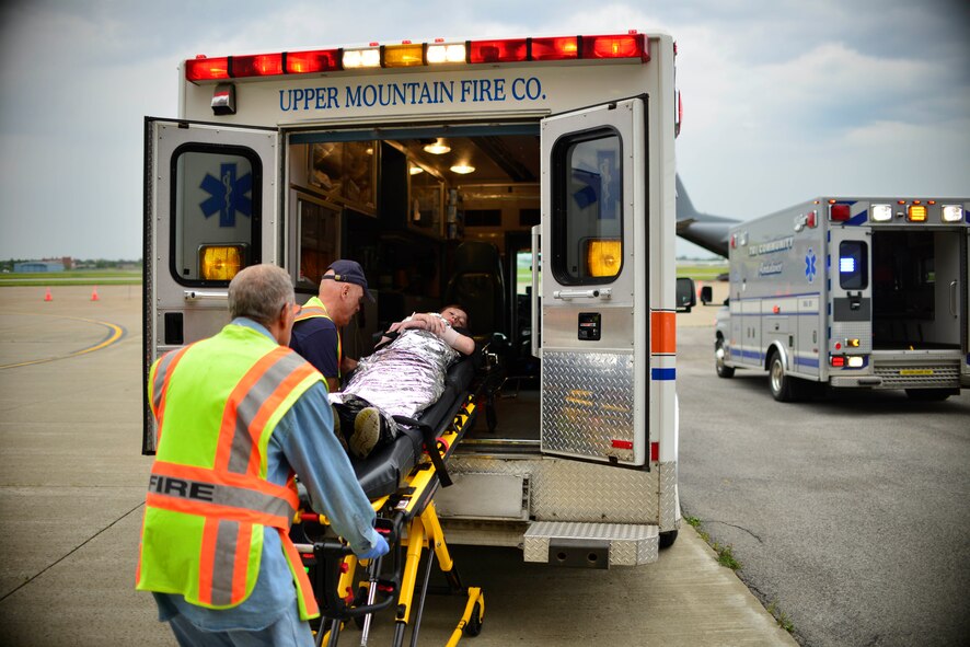 Emergency Response personnel load a victim of a simulated C-130 Aircraft hard landing (or crash) into an ambulance as part of the MARE (Major Accident Response Exercise), June 27, 2015, Niagara Falls Air Reserve Station, N.Y. The MARE is an important part of keeping Niagara’s team ready to respond in an emergency situation. (U.S. Air Force photo by Tech. Sgt. Stephanie Sawyer) 