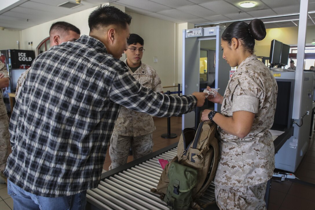 U.S. Marine Cpl. Jun Cho, left, a field wireman, attempts to keep medication hidden from Lance Cpl. Karina Lopez Campos, a water support technician, during evacuation control center sustainment training aboard Naval Air Station Sigonella, Italy, May 27, 2015. Both Marines are assigned to Special-Purpose Marine Air-Ground Task Force Crisis Response-Africa. More than 30 Marines participated in the training, which helped refresh their evacuation control center skills. (U.S. Marine Corps photo by Cpl. Lucas Hopkins/Released)