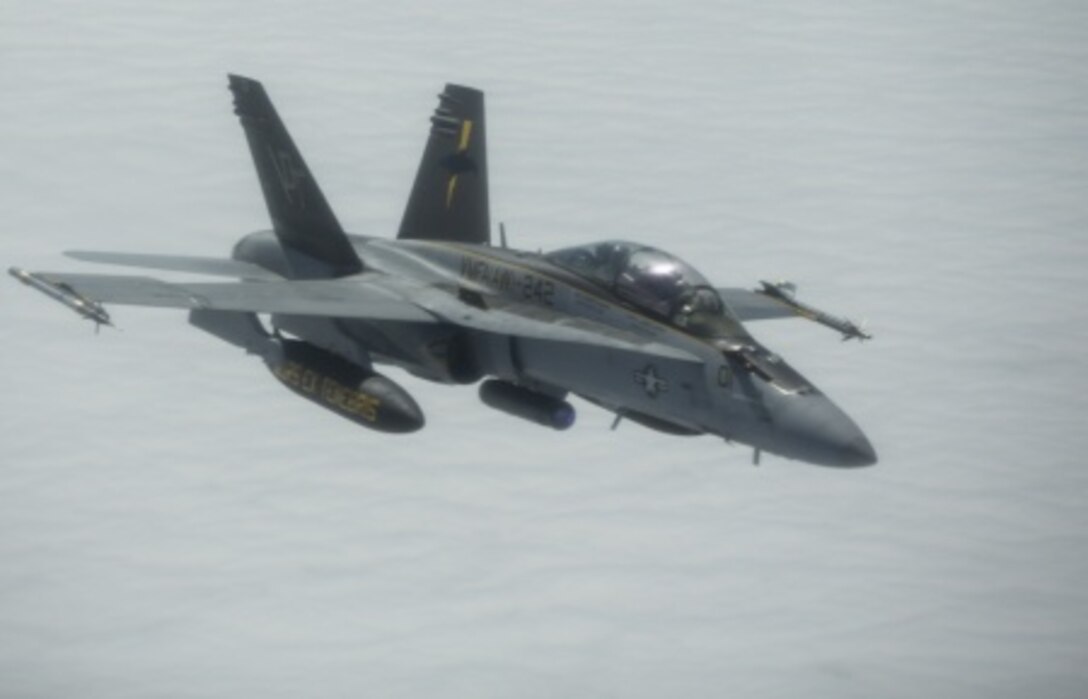 A U.S. Marine Corps F/A-18D Hornet aircraft, assigned to the Marine All-Weather Fighter Attack Squadron 242, 1st Marine Aircraft Wing, flies over the Gulf of Alaska, June 22, 2015. The aircraft was being refueled while flying a training mission during Exercise Northern Edge 15. Northern Edge is Alaska’s premier joint training exercise designed to practice operations, techniques and procedures as well as enhance interoperability among the services. Thousands of Airmen, Soldiers, Sailors, Marines and Coast Guardsmen from active duty, reserve and National Guard units are involved.