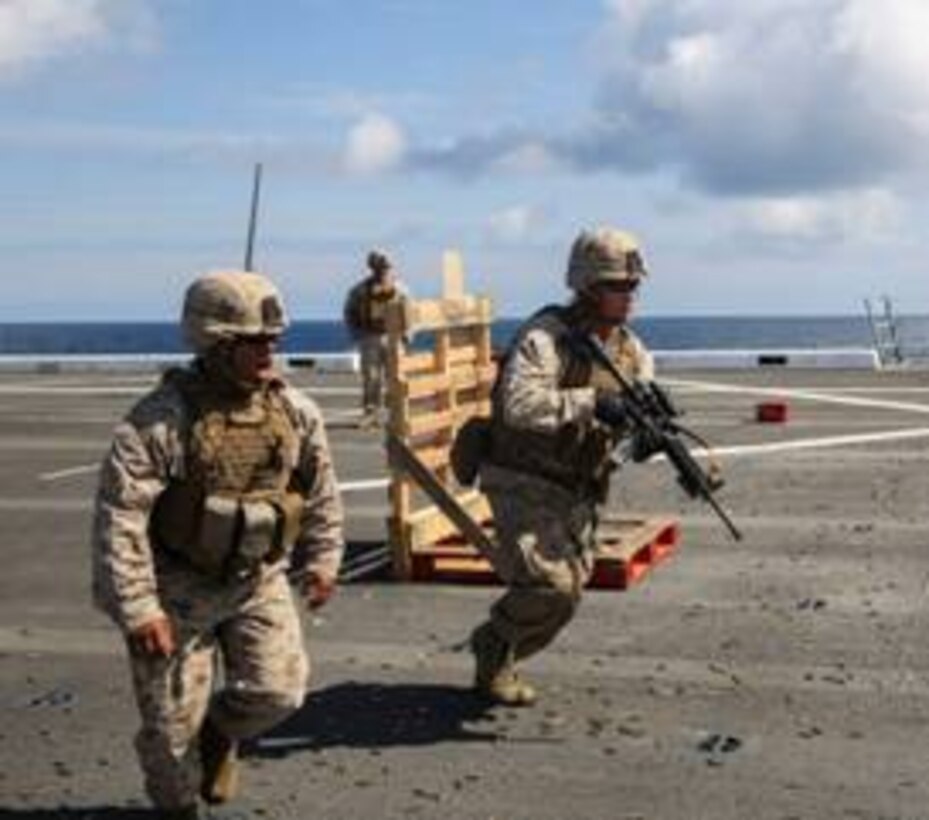 Sergeant Matthew Sanford right, a squad leader with 2nd Platoon, Charlie Co., 1st Battalion and native of Rochester, New York, rushes to the next target during a close-quarters training exercise aboard the USS San Antonio LPD 17 en route from New York City to Europe, May 26-June 6 2015. BALTOPS is an annual exercise that provides the opportunity for the North Atlantic Treaty Organization (NATO) and regional partners to strengthen inoperability through a series of tactical maneuvers and scenarios. The exercise involves Marines, Sailors, Airmen, and Soldiers of participating nations working side-by-side to enhance each other’s tactics and expertise, both on land and sea. (U.S. Marine Corps photo by Lance Cpl. Immanuel Johnson/Released)