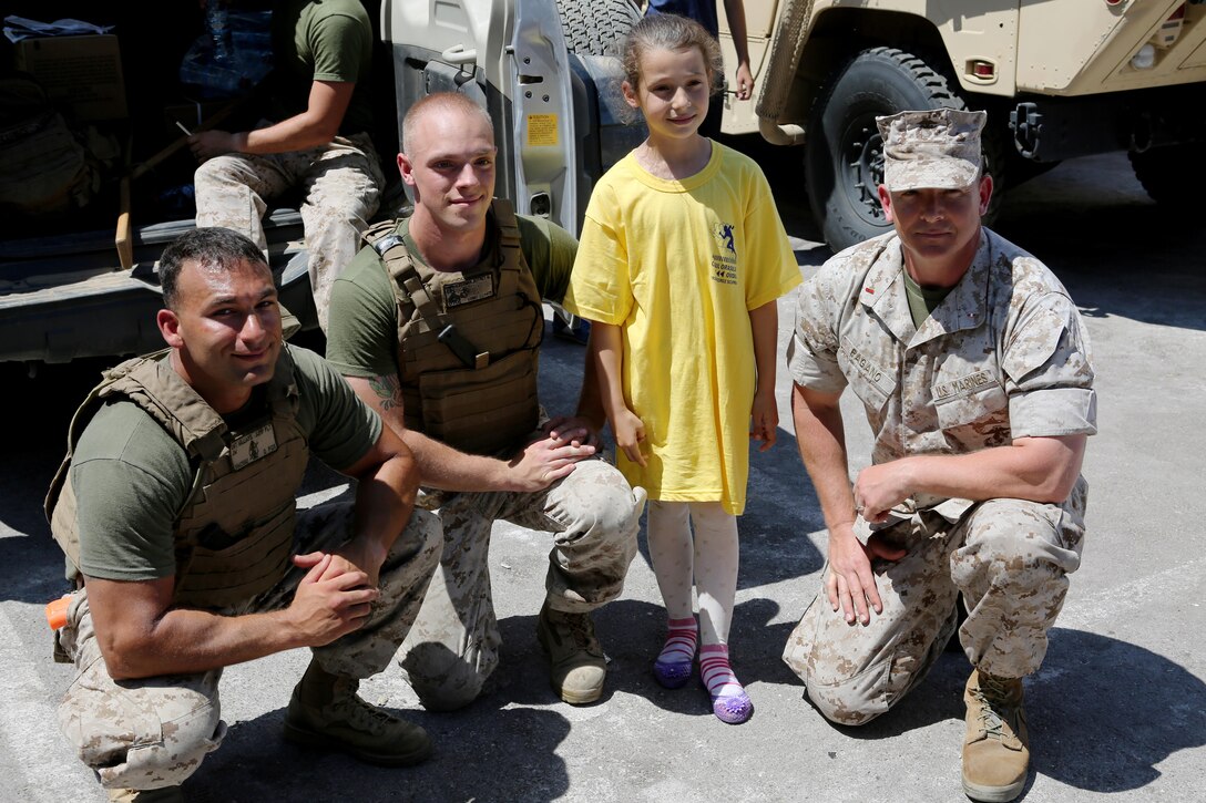 (From left to right) U.S. Marines Sgt. John Williams, Cpl. Jeffrey Ackerman and Warrant Officer Chris Pagano, with Black Sea Rotational Force, volunteered at Ovidiu City Days, May 31. Thousands of Romanians attended the Ovidiu City Days event, May 31, to commemorate the town’s anniversary and celebrate National Children's’ Day in Romania. U.S. Marines with Black Sea Rotational Force and service members from the Romanian Army volunteered at the event.  (Official U.S. Marine Corps photo by Cpl. Ashton Buckingham)