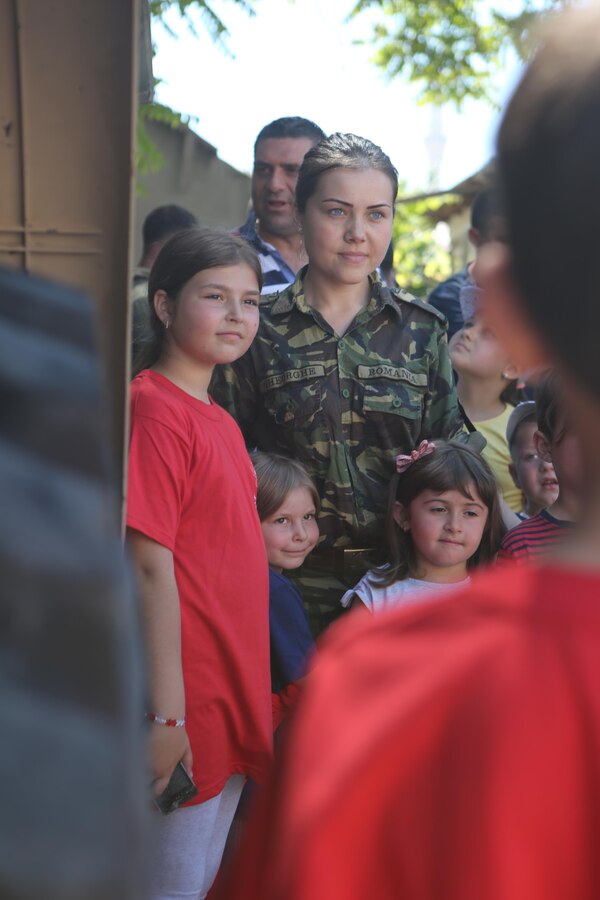 Romanian Lt. Mirela Gheorghe takes a photo with some of the attendees of the Ovidiu City Days event, May 31. Thousands of Romanians came out to celebrate the town’s anniversary and National Children's’ Day in Romania. U.S. Marines with Black Sea Rotational Force and service members from the Romanian Army volunteered at the event. (Official U.S. Marine Corps photo by Cpl. Ashton Buckingham)