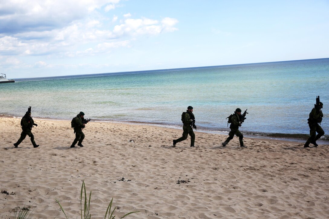 Swedish Marines extract from a beach head in Sweden and practice an amphibious assault during BALTOPS 2015, June 9. BALTOPS is an annual, multinational exercise designed to enhance the operational familiarity of NATO Allies and partner nations and demonstrate the capabilities to defend the Baltic region.