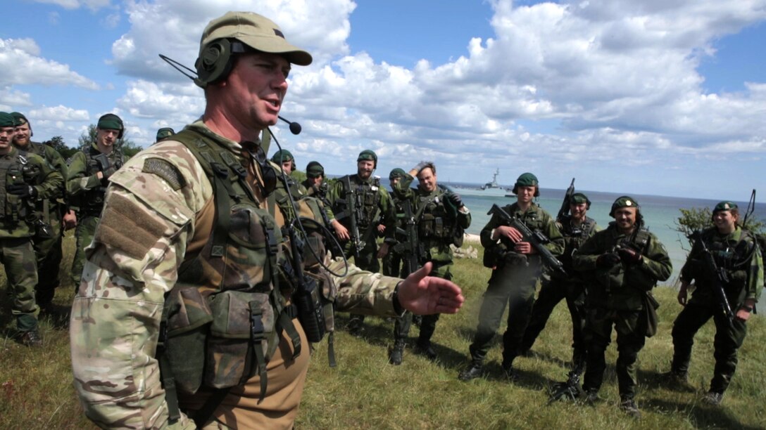 A U.K. Royal Marine Commando gives feedback to Finnish Marines after they simulated an amphibious assault on a Swedish beachhead during BALTOPS 2015, June 10. In its 43rd iteration, BALTOPS is a multinational exercise designed to enhance the operational familiarity of NATO allied and partner nations and demonstrate their collective capability to defend the Baltic region.